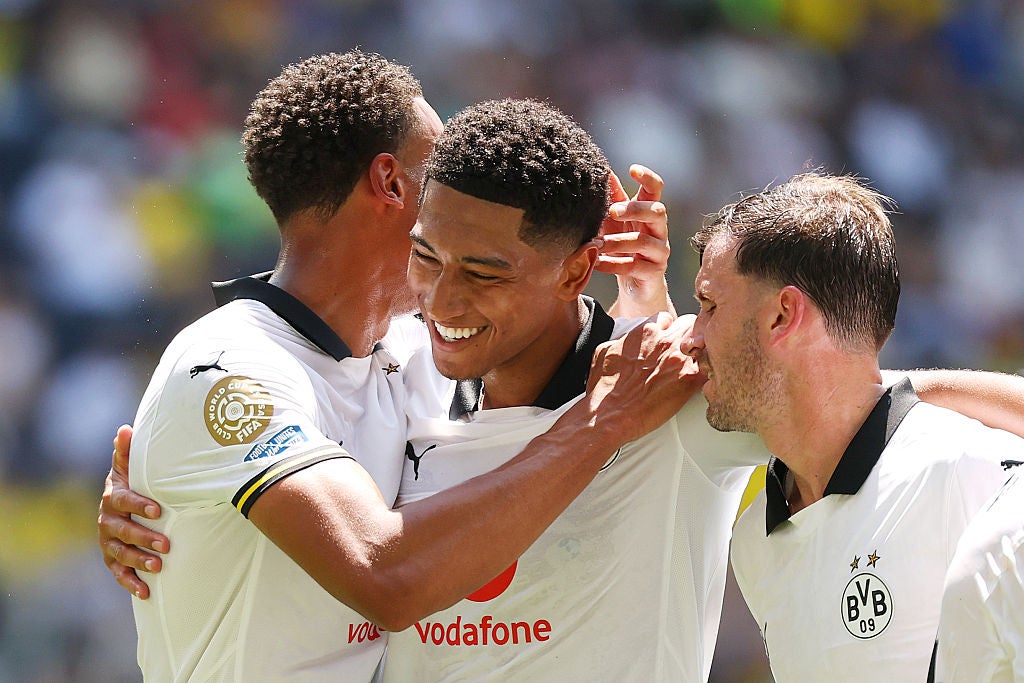 Jobe Bellingham of Borussia Dortmund celebrates scoring his team's third goal with Felix Nmecha and Pascal Gross