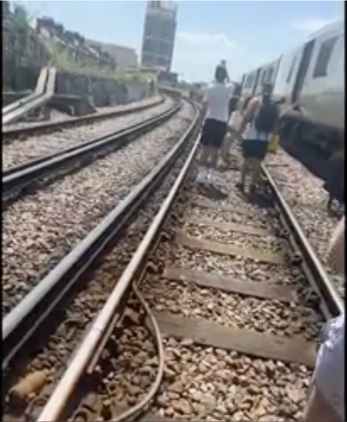 Passengers were forced to walk along the tracks in the heat