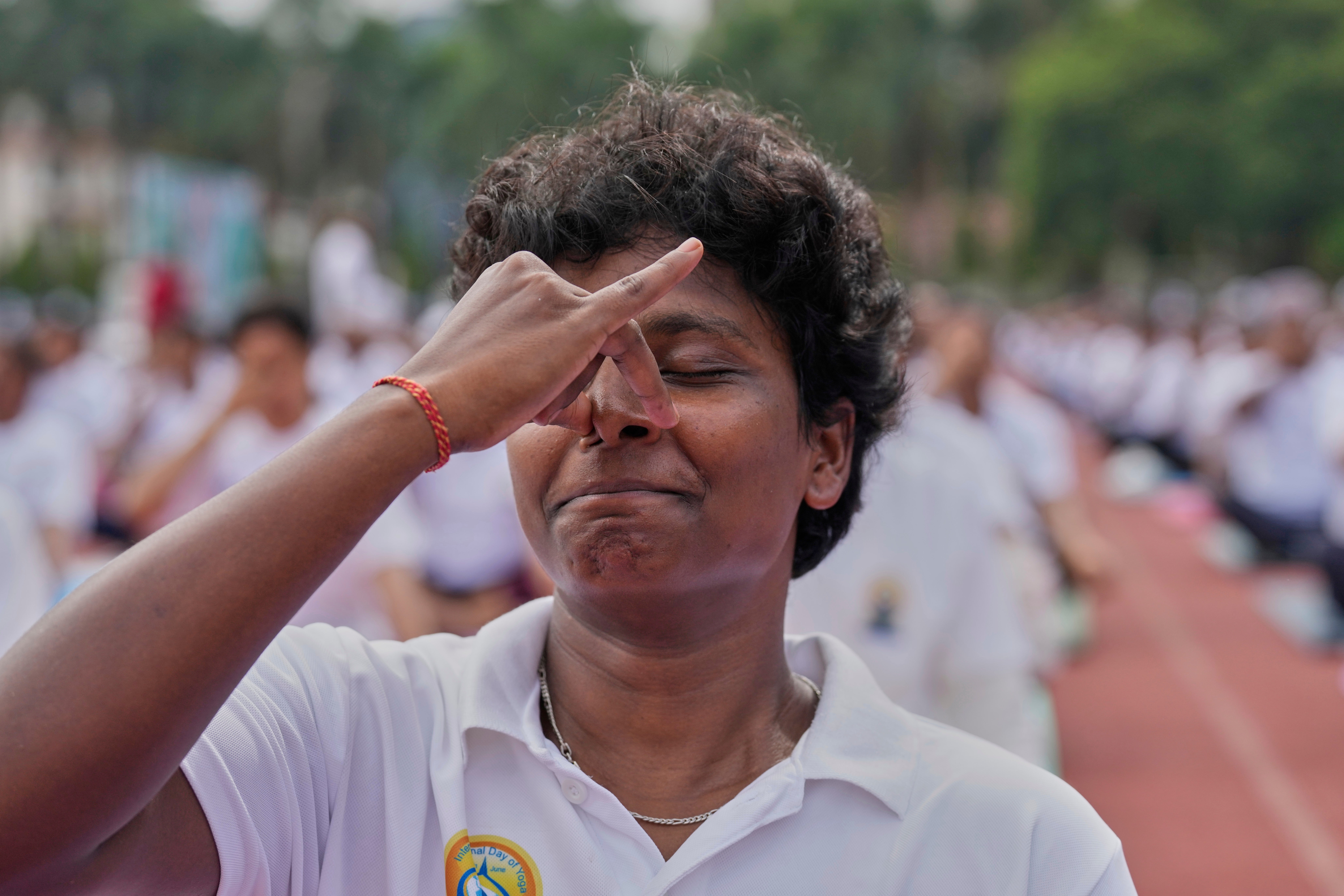 Indians perform yoga to mark International Day of Yoga at a playground in Guwahati