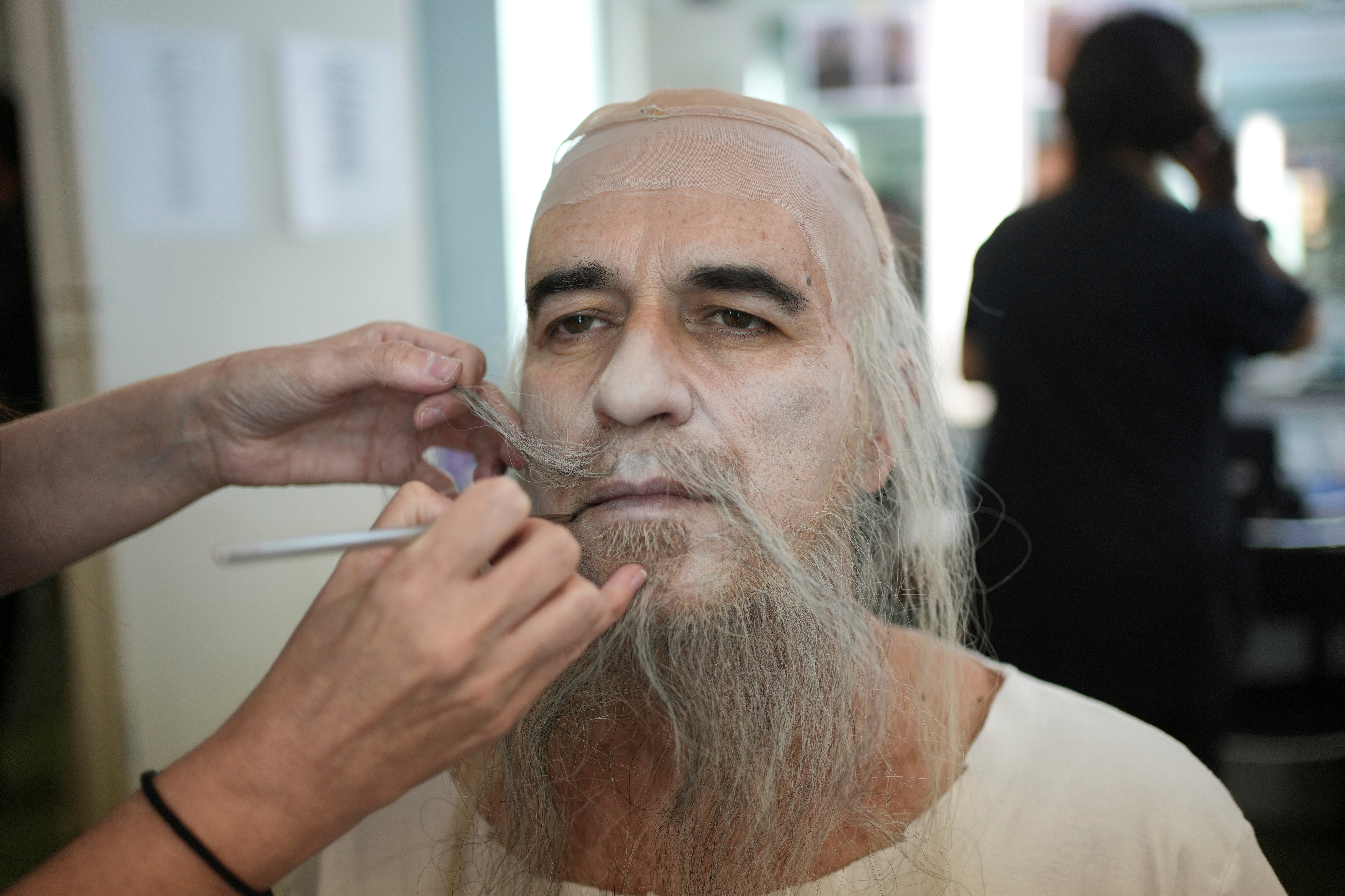 Tenor Nikos Stefanou gets his make-up ahead of Giacomo Puccini's "Turandot" performance during the 70th Athens Epidaurus Festival at the Odeon of Herodes Atticus in Athens, Greece, Tuesday, June 3, 2025. (AP Photo/Thanassis Stavrakis)