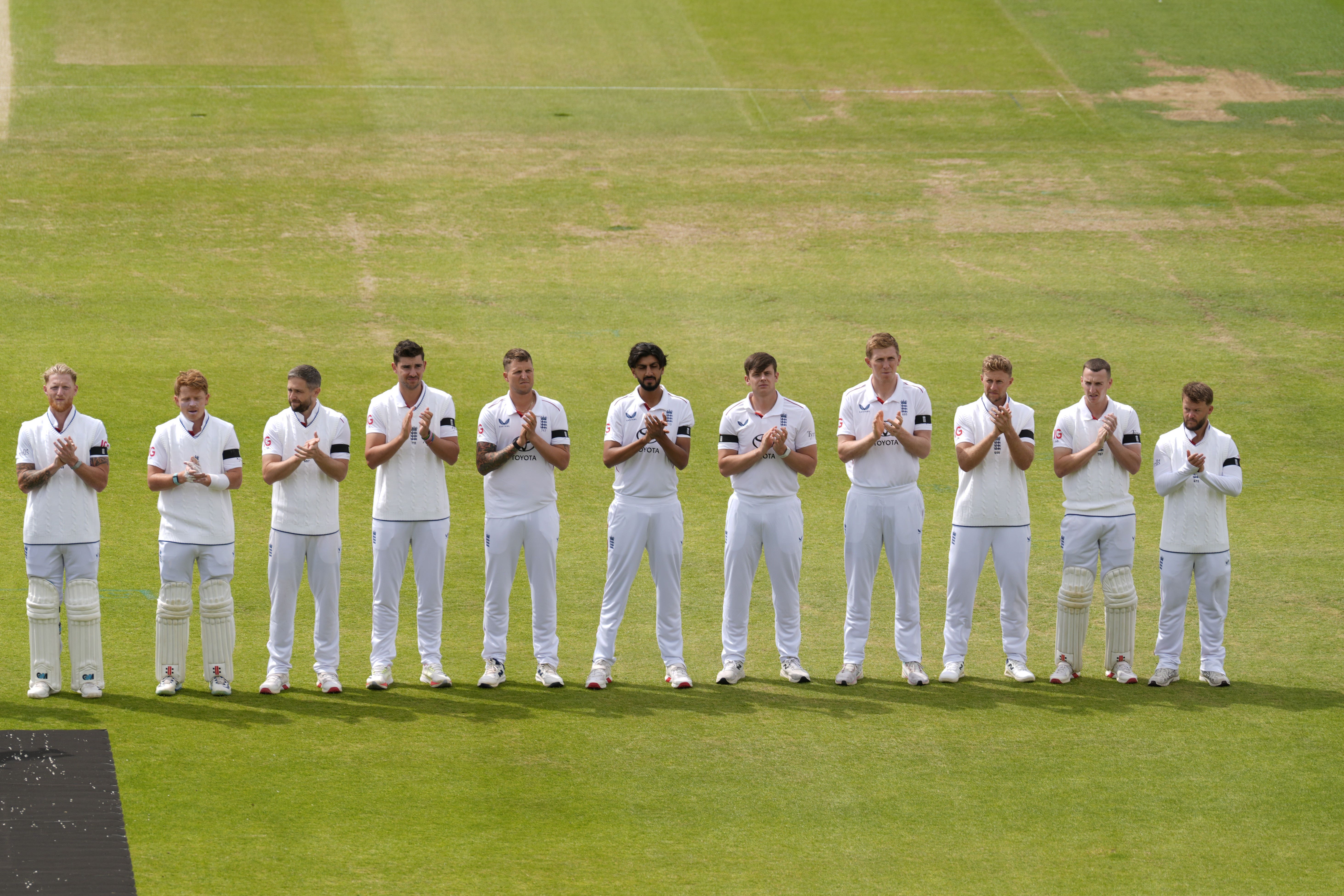 England players take part in a minute’s applause for the late David Lawrence ahead of day three of the India Test (Danny Lawson/PA)