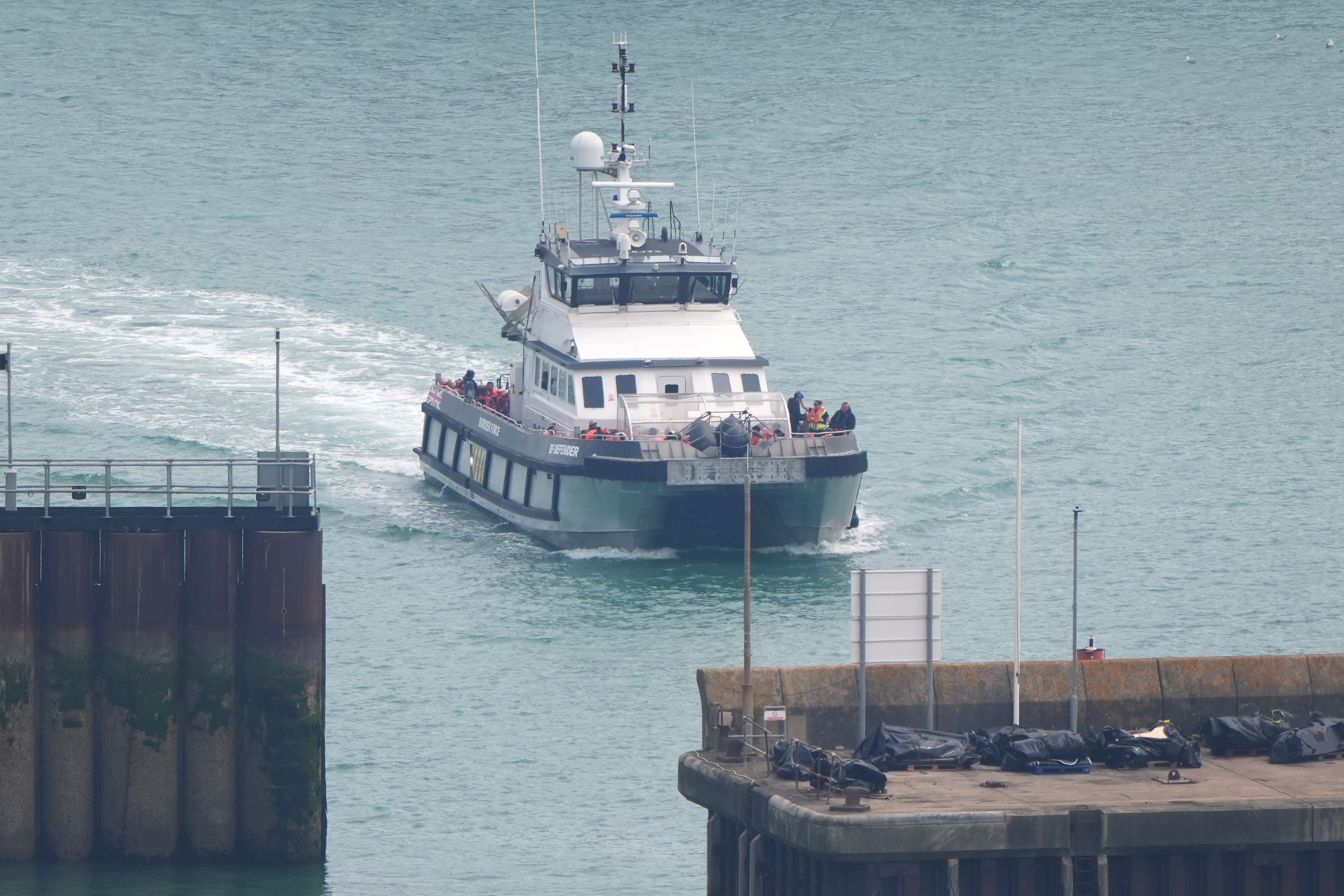A group of people thought to be migrants are brought in to Dover, Kent, onboard a Border Force vessel on Friday (Gareth Fuller/PA)