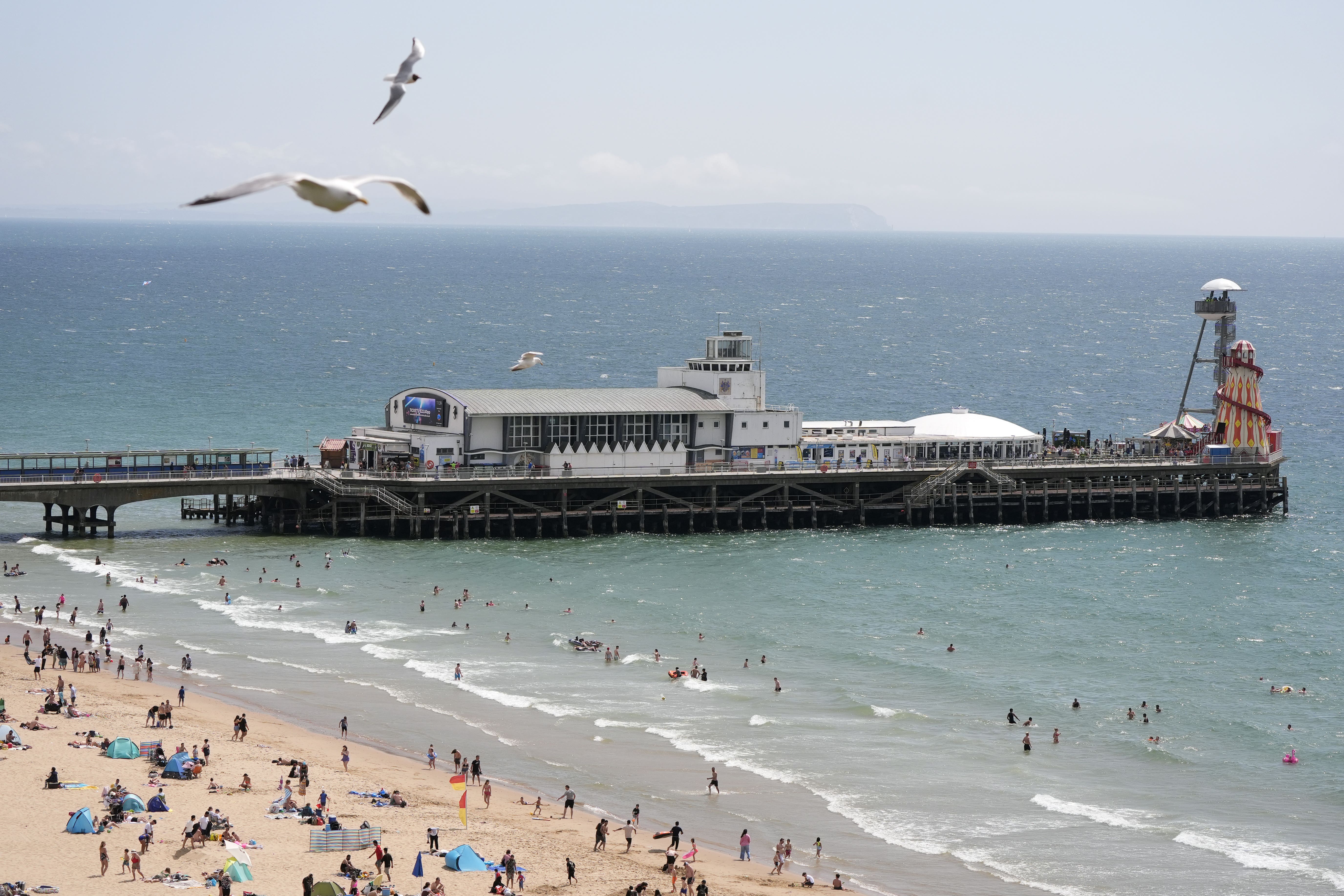 People enjoying the warm weather on Bournemouth Beach in Dorset on Sunday (Andrew Matthews/PA)