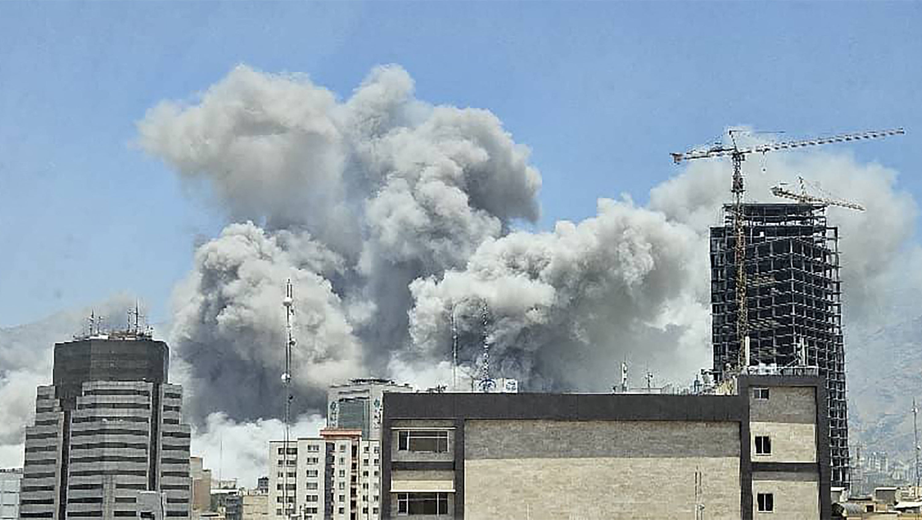 A plume of smoke billows after Israeli strikes in Tehran. Israel said it struck Iran Revolutionary Guards sites in Tehran and the city's notorious Evin prison on Monday