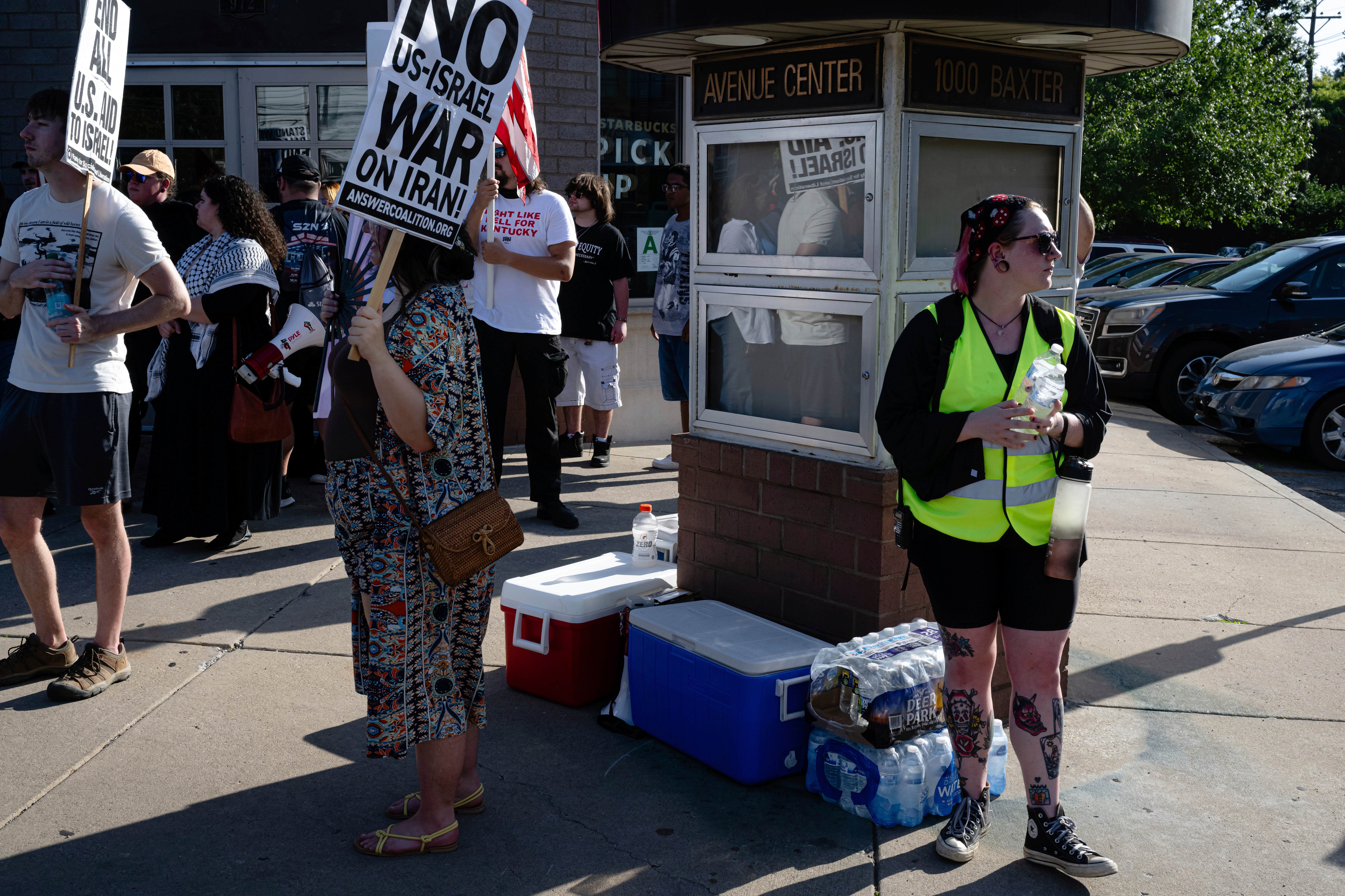People protest in Louisville, Kentucky, as a worker hands out water. Staying hydrated is critical to staying safe in hot weather