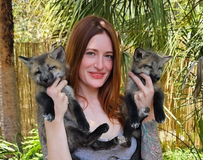 Mikayla Raines pictured with rescued foxes