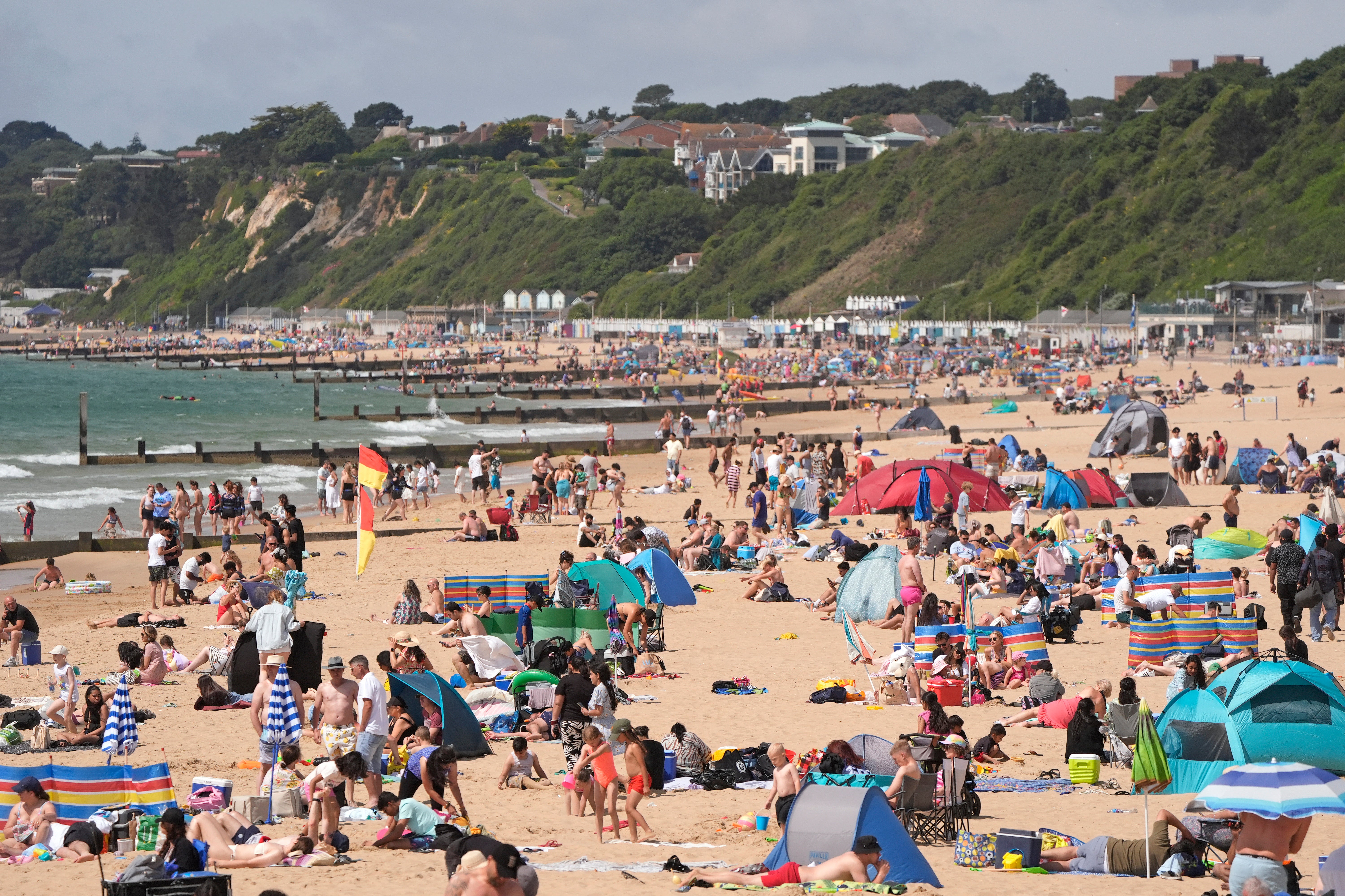 People enjoy the warm weather on Bournemouth Beach in Dorset