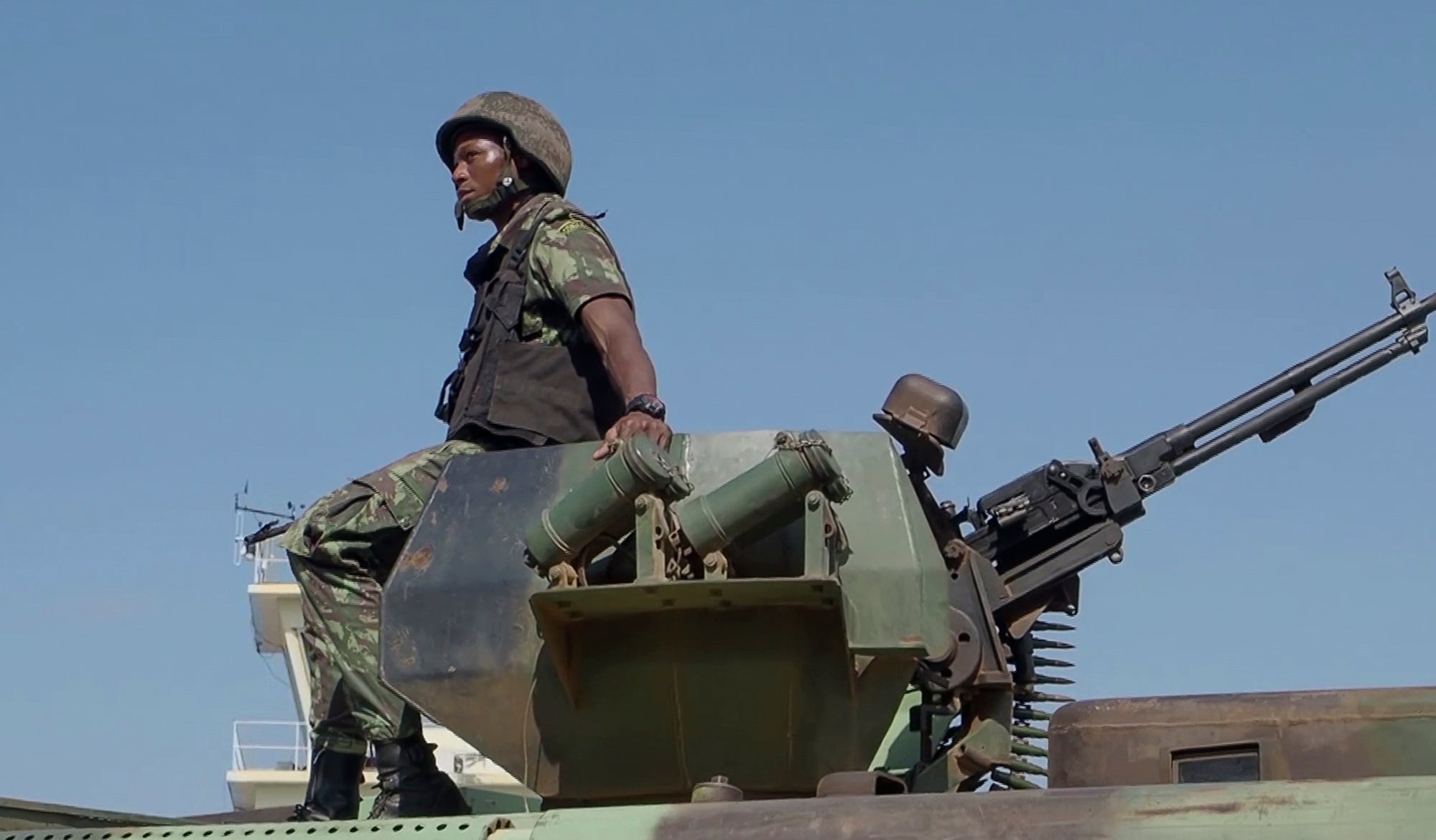 In this image made from video, a Mozambican soldier rides on an armored vehicle at the airport in Mocimboa da Praia, Cabo Delgado province, Mozambique, Aug. 9, 2021