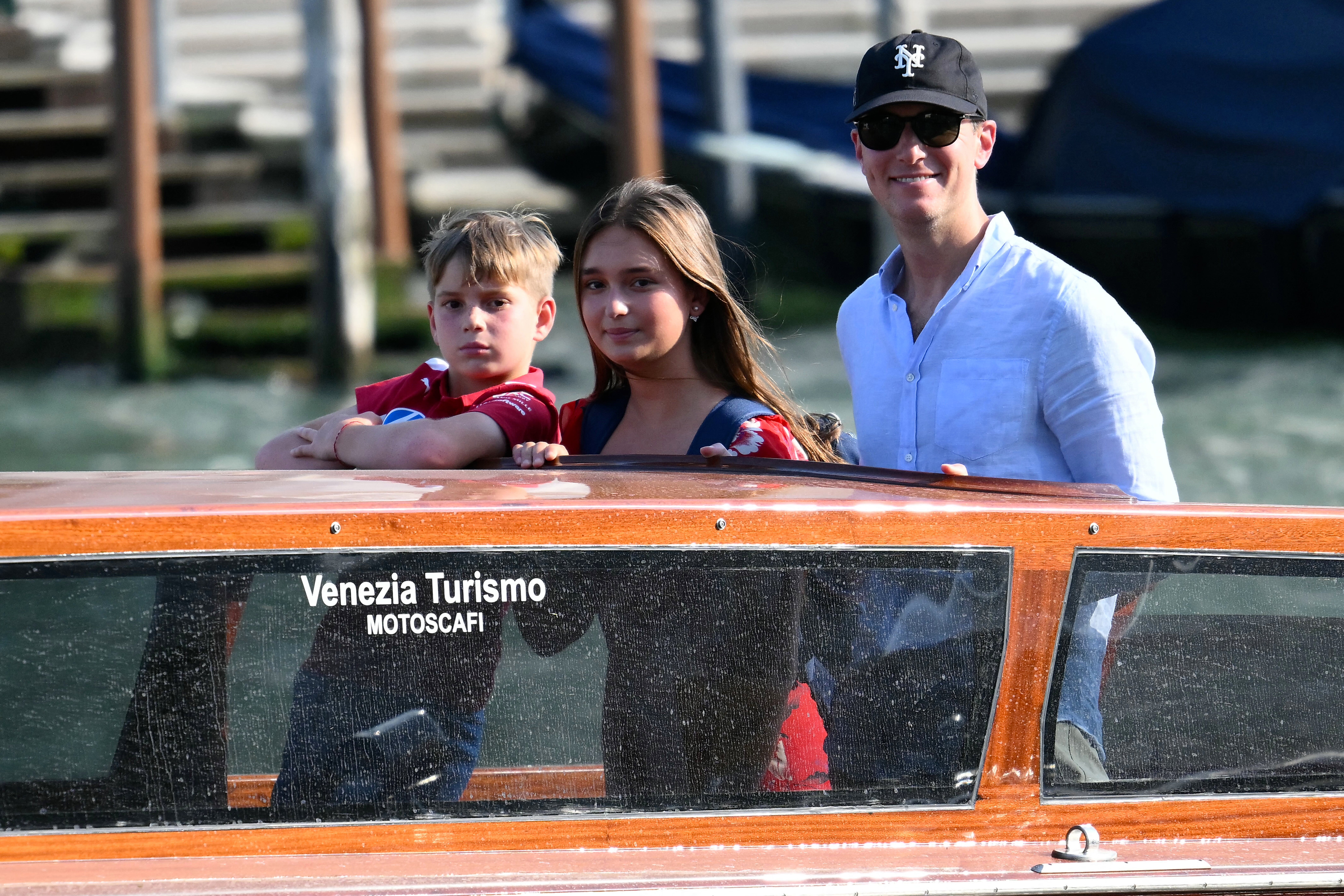 Jared Kushner and two of his children stand on a taxi boat as they arrive at the St Regis Hotel ahead of the wedding of Amazon founder Jeff Bezos in Venice on June 24, 2026. Celebrities in superyachts sail