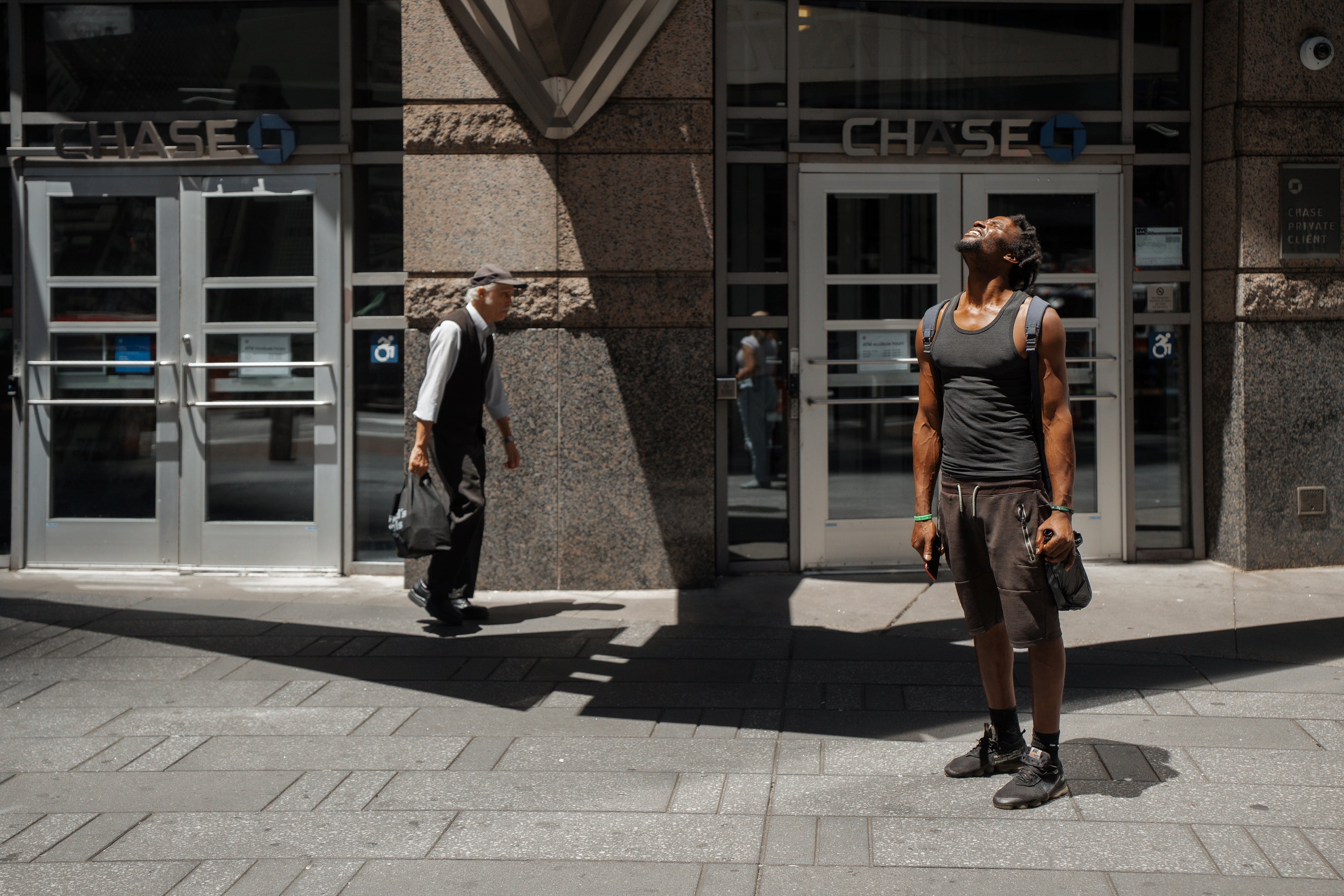 A man squints at the sun during a heatwave