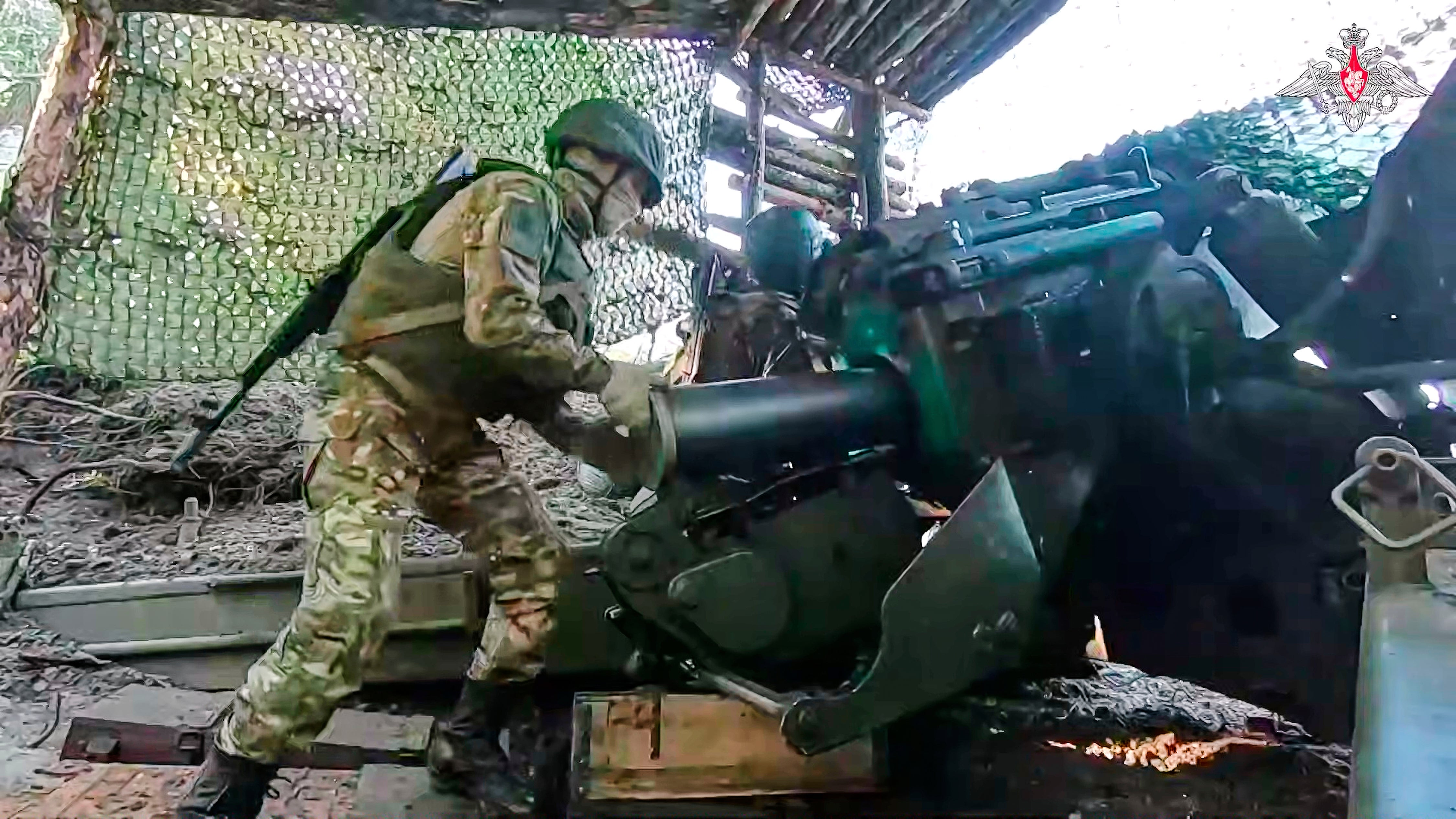 A Russian soldier prepares a Giatsint-B 152mm field gun to fire towards a Ukrainian position at an undisclosed location in Ukraine earlier this month