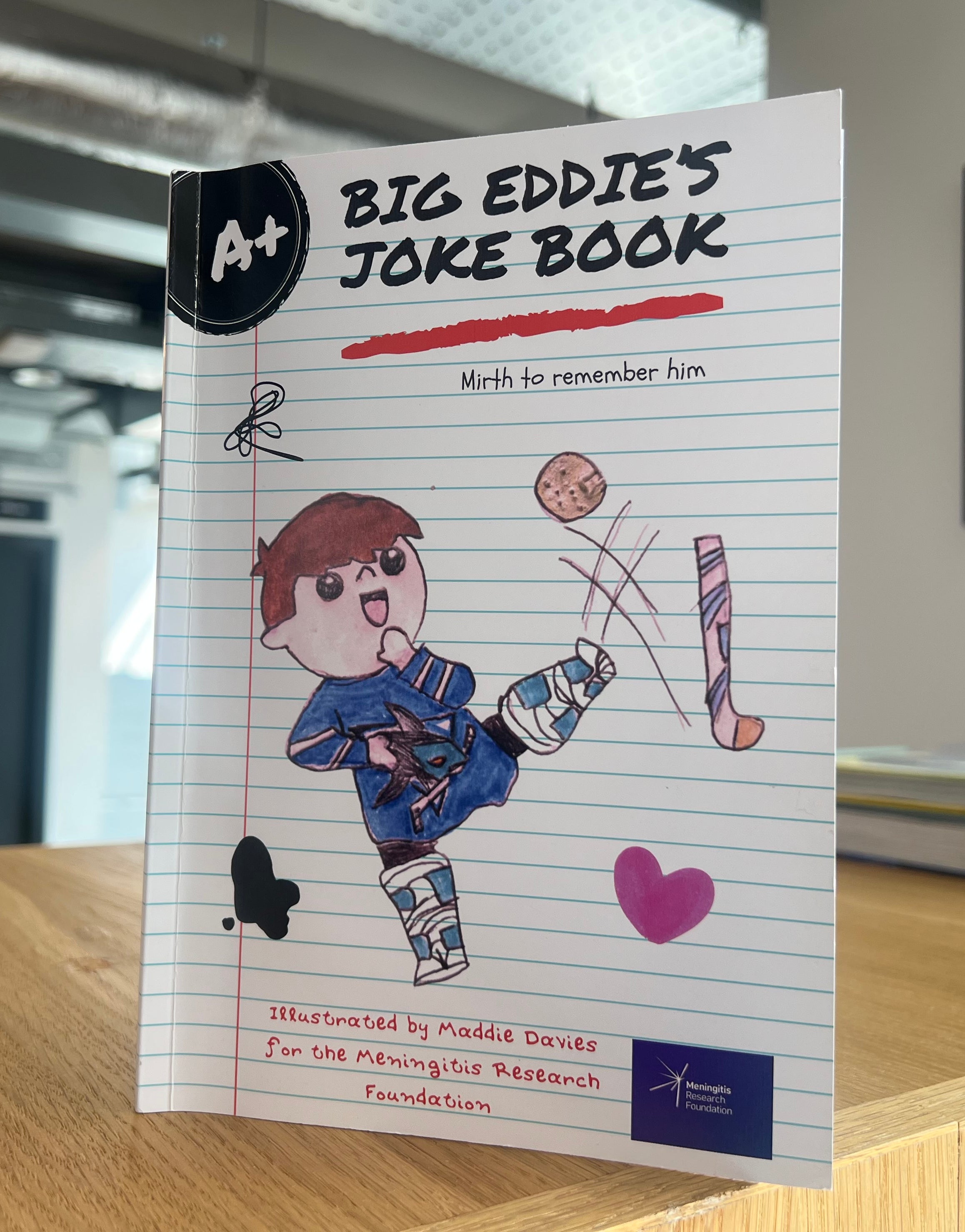 Former teammates of a hockey player who died from meningitis 25 years ago have created a joke book to raise awareness and funds for a charity researching the disease