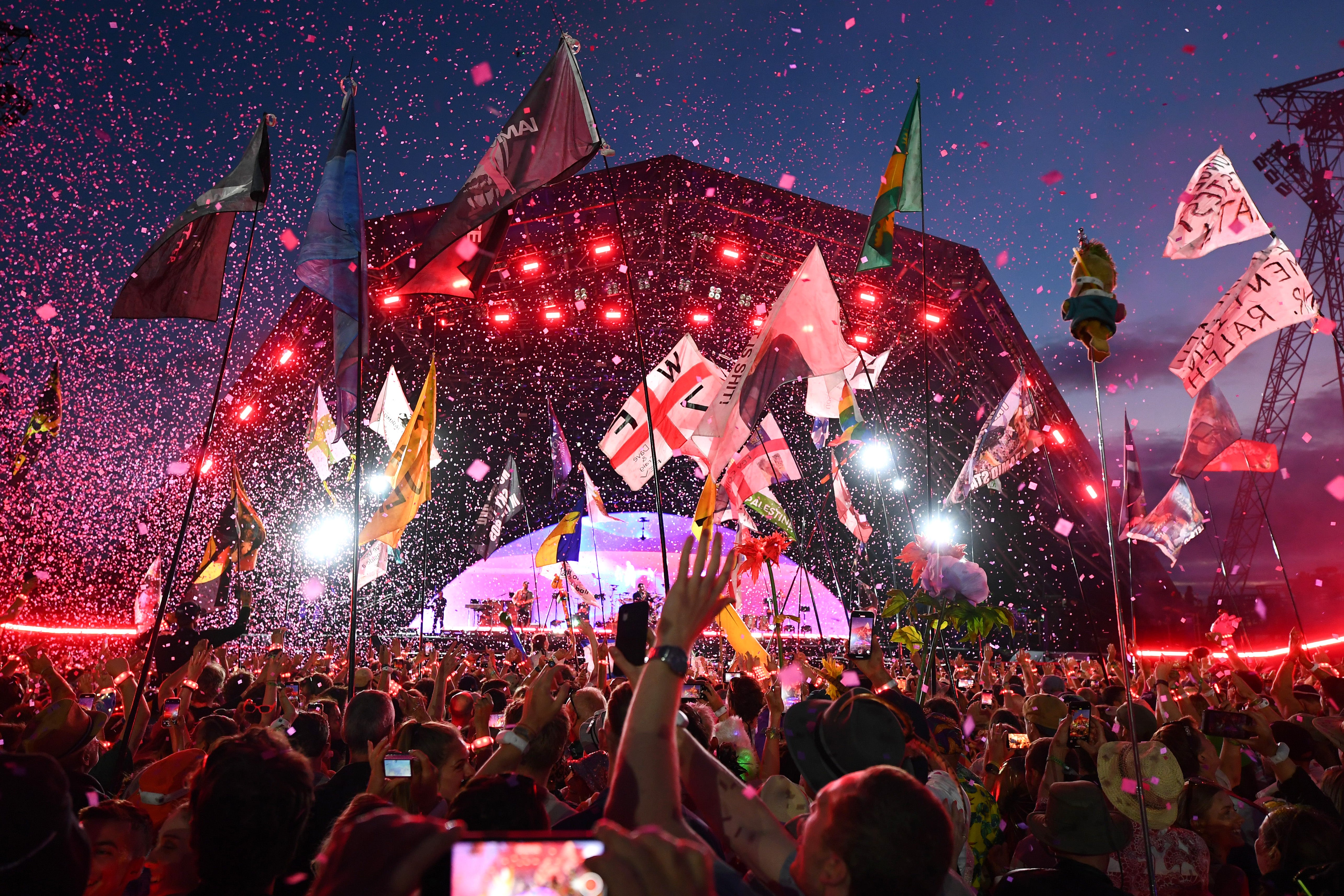 Crowds watch Coldplay headline the Pyramid Stage at Glastonbury in 2024