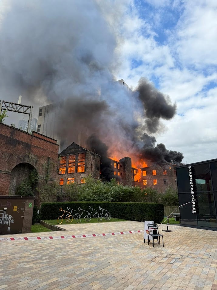 Firefighters attend the scene of a major fire at Hotspur Press buildings, Manchester