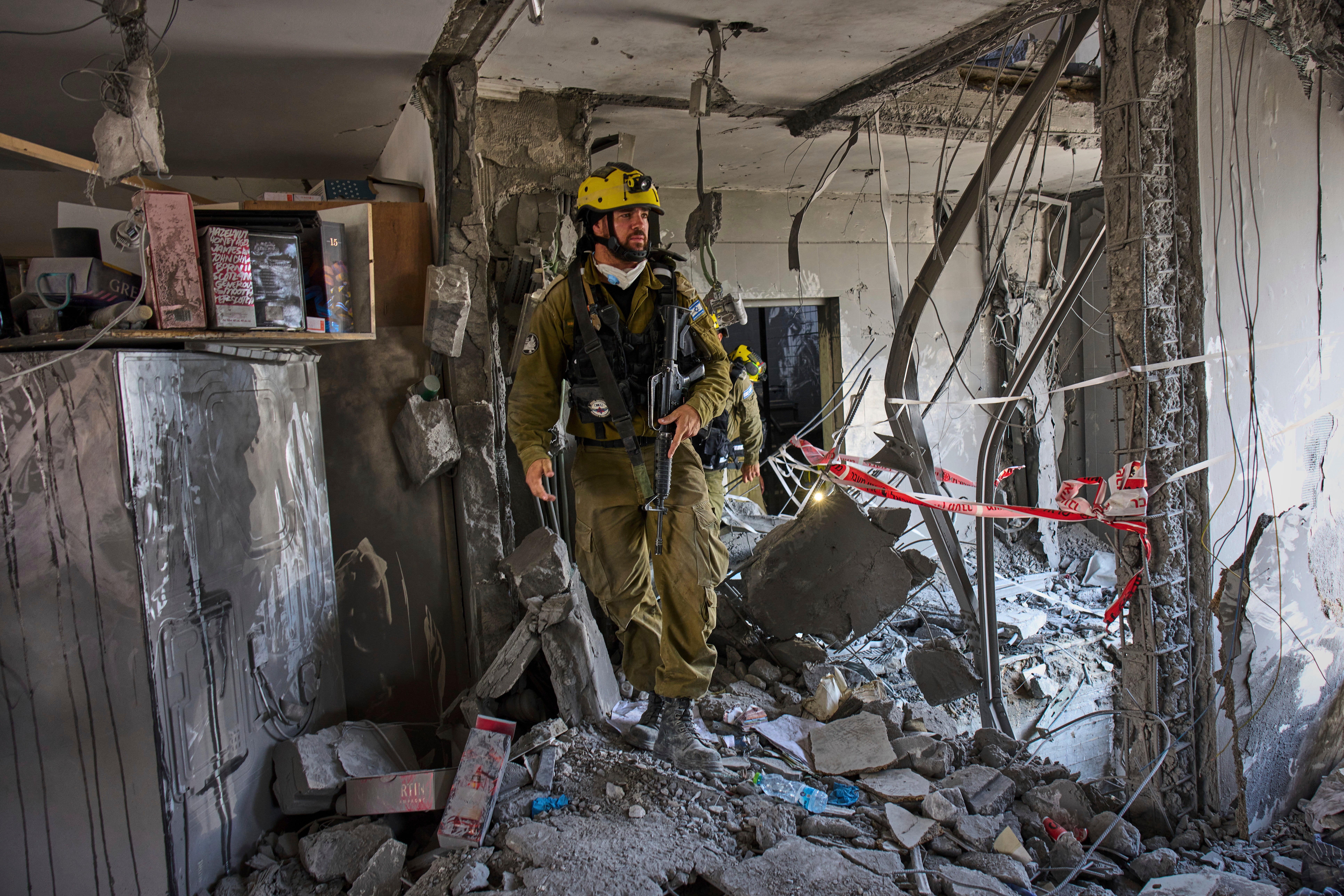 Israeli soldiers amid the rubble of residential buildings destroyed by an Iranian missile strike that killed several people, in Beersheba, Israel, on Tuesday