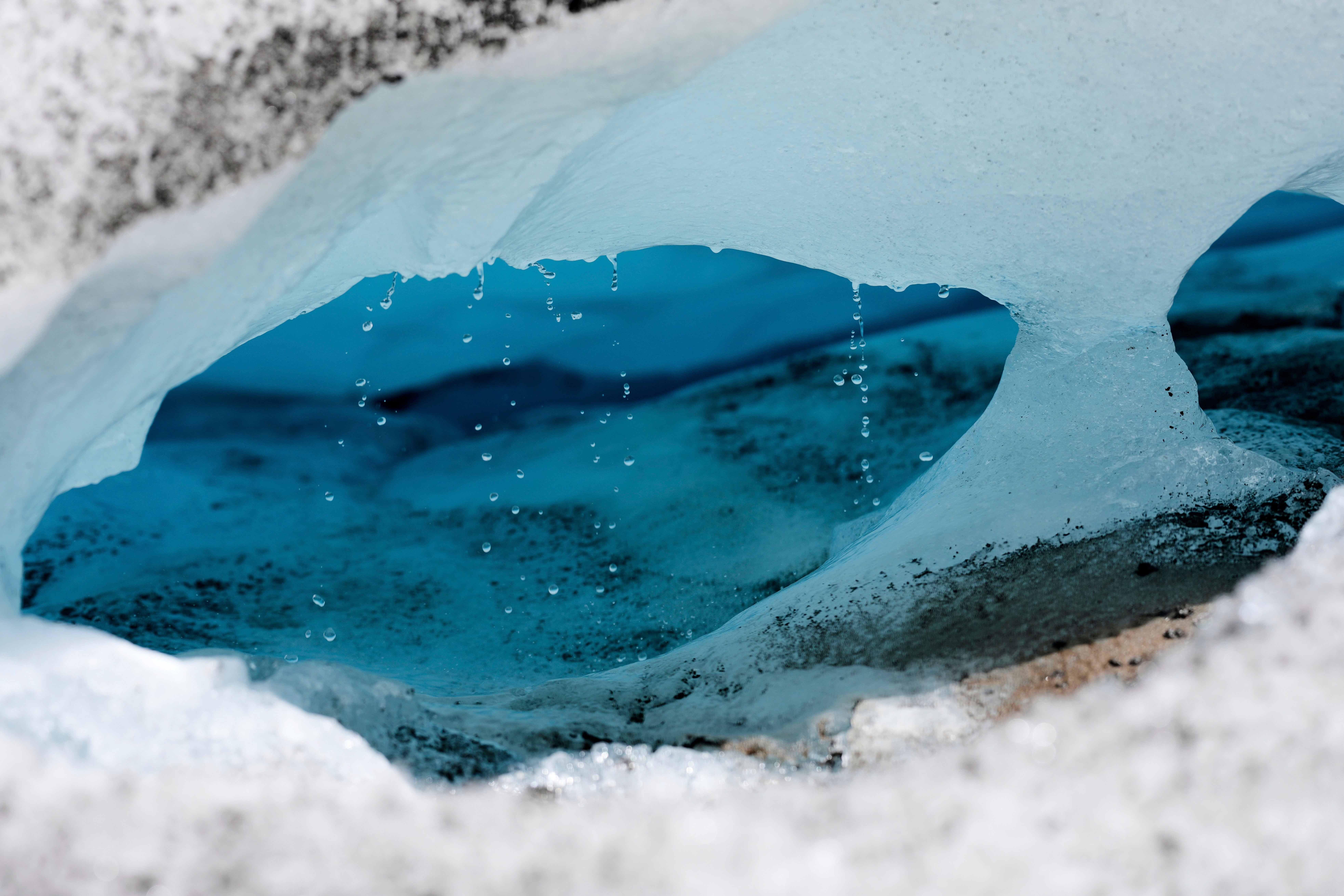 Water drips from a melting chunk of ice that originated from the Rhone glacier near Goms, Switzerland, June 10, 2025. (AP Photo/Matthias Schrader)
