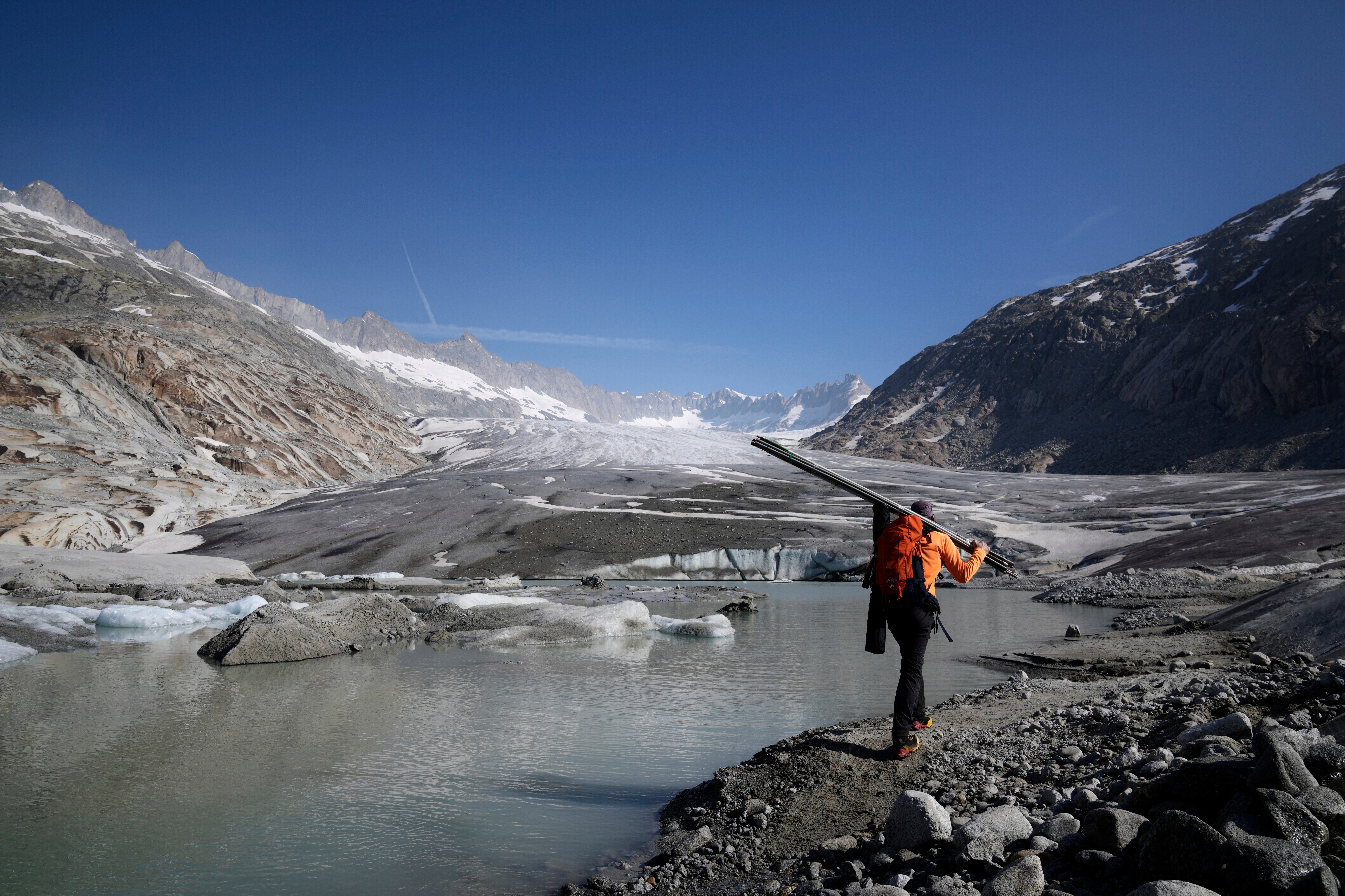 Matthias Huss, of the Federal Institute of Technology in Zurich and glacier monitoring group GLAMOS, arrives at the Rhone Glacier near Goms, Switzerland, June 10, 2025. (AP Photo/Matthias Schrader)