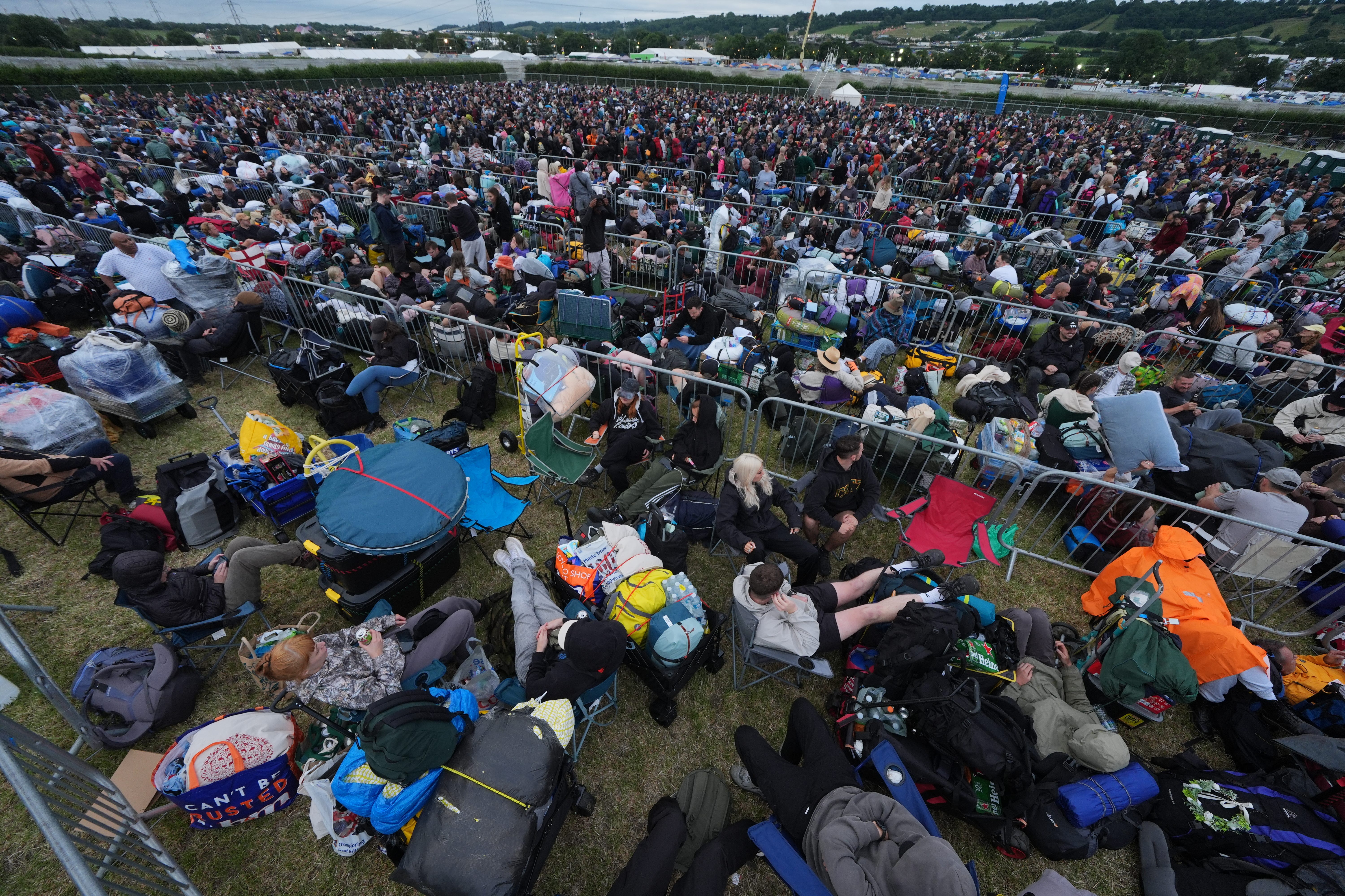 Revellers queue for entry on the first day of the Glastonbury Festival at Worthy Farm in Somerset (Yui Mok/PA)