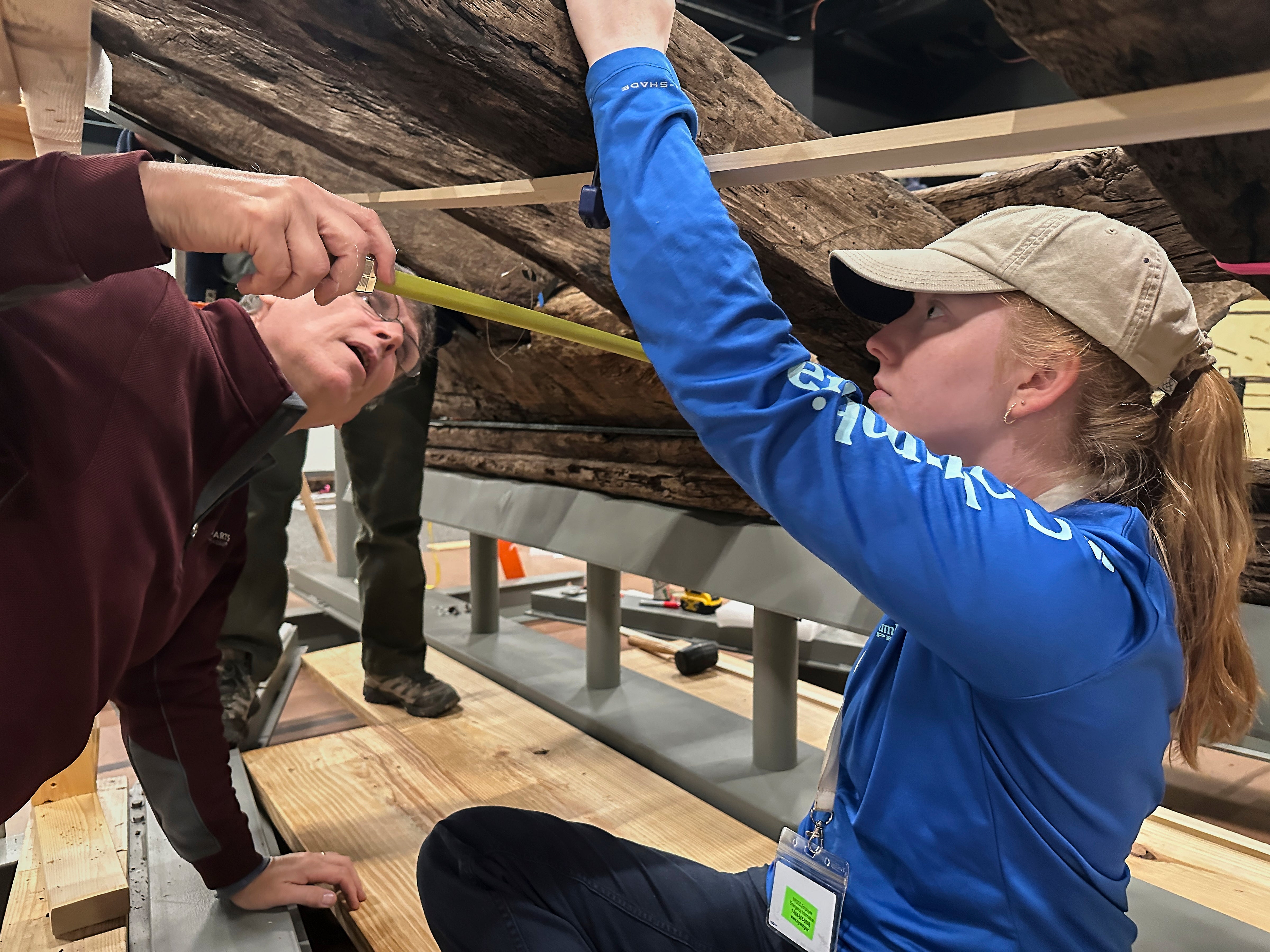 Peter Fix, left, and Alyssa Carpenter of Texas A&M's Center for Maritime Archaeology and Conservation work on a wooden Revolutionary War-era gunboat at the New York State Museum, Friday, May 30, 2025, in Albany, New York. (AP Photo/Michael Hill)