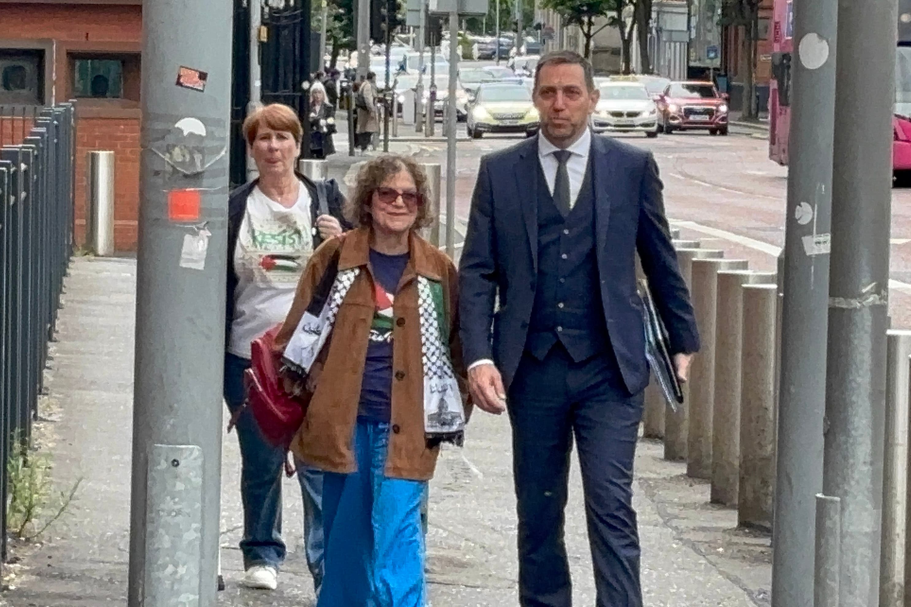 Martine McCullough and Sue Pentel and their solicitor Padraig O Muirigh arrive at Musgrave Street police station in Belfast for a pre arranged police interview after the pair were arrested earlier this year at a pro-Palestine protest outside a Barclays bank (Rebecca Black/PA)