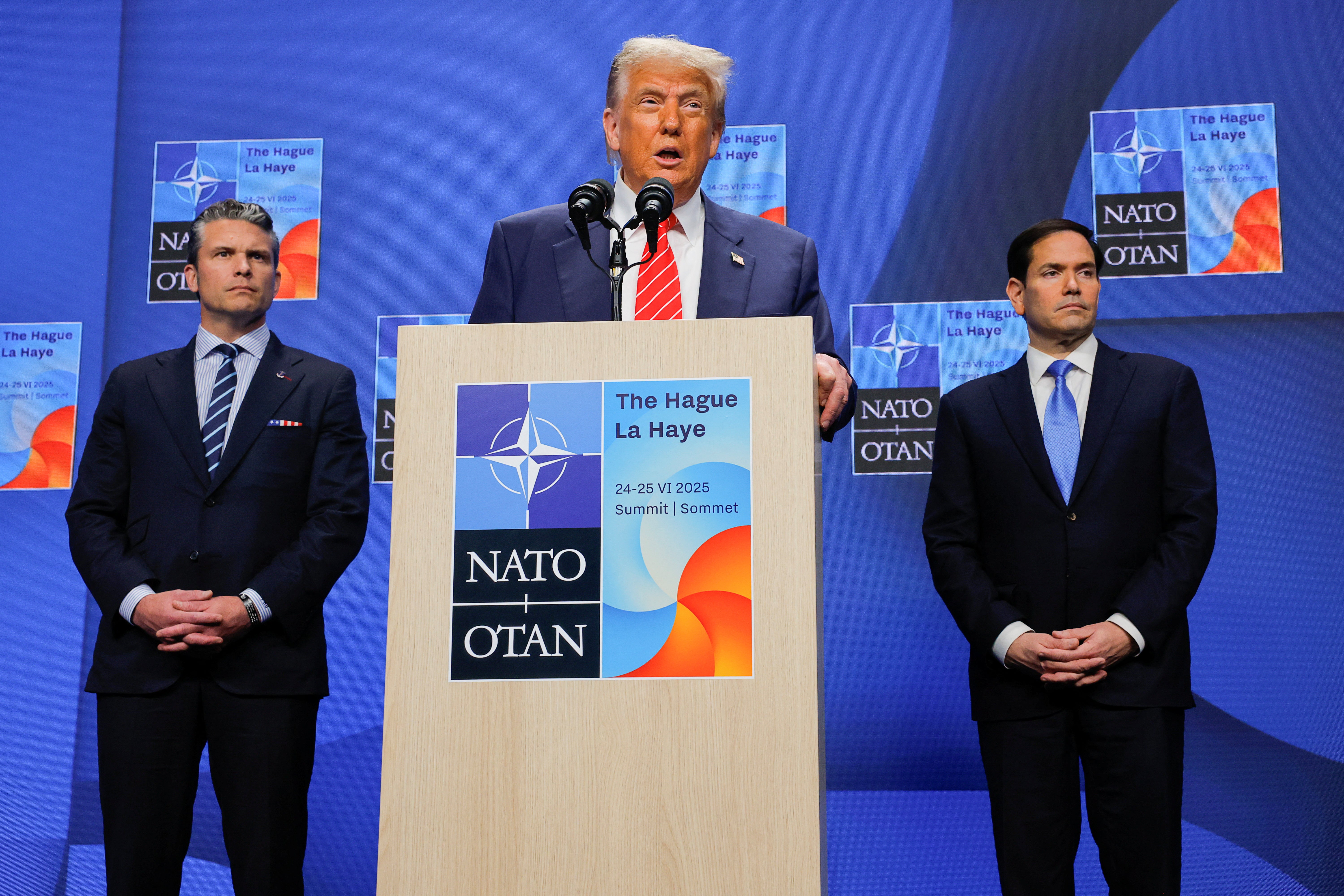 President Donald Trump, flanked by Hegseth and Secretary of State Marco Rubio, takes questions in The Hague