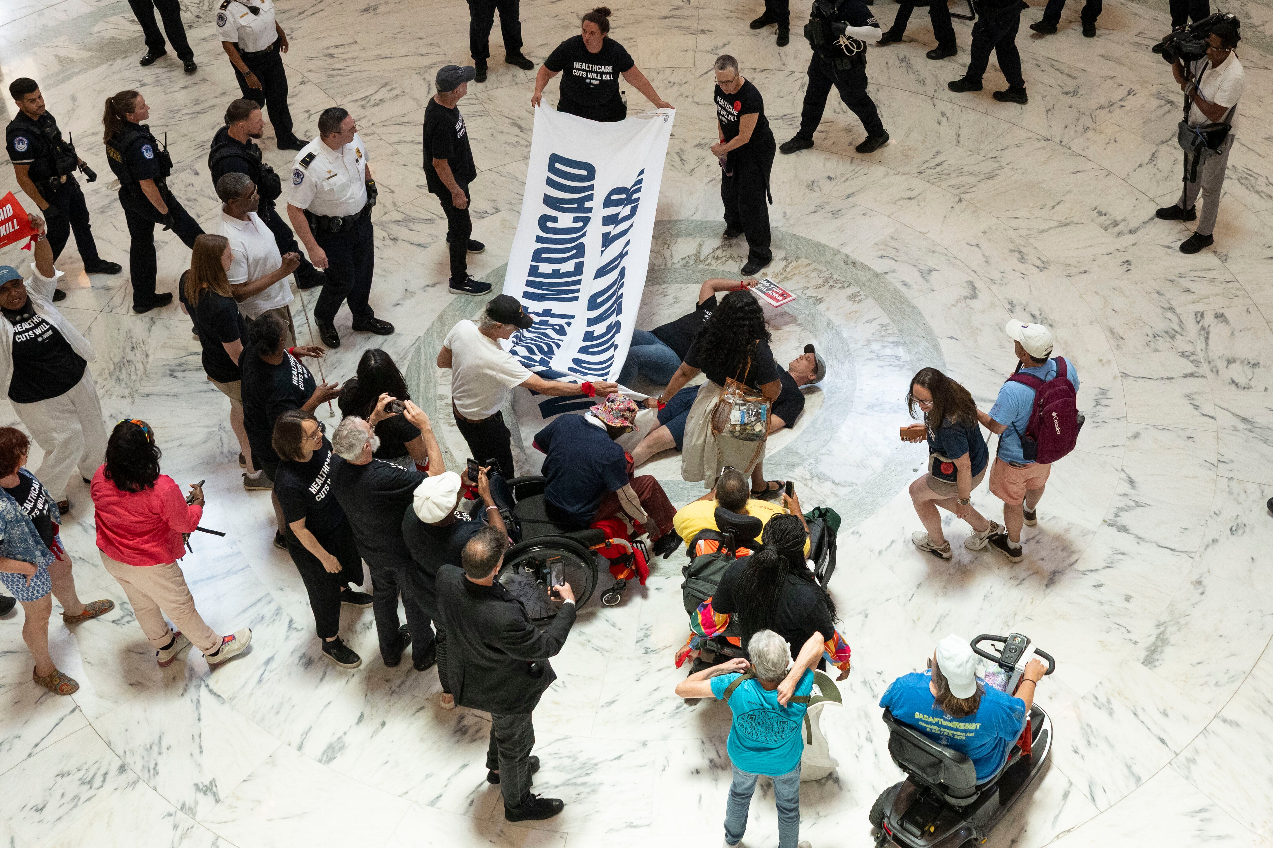 Protesters unfurled banners and chanted ‘kill the bill’ as Congress prepares to vote on Trump’s sweeping legislation that include steep cuts to Medicaid