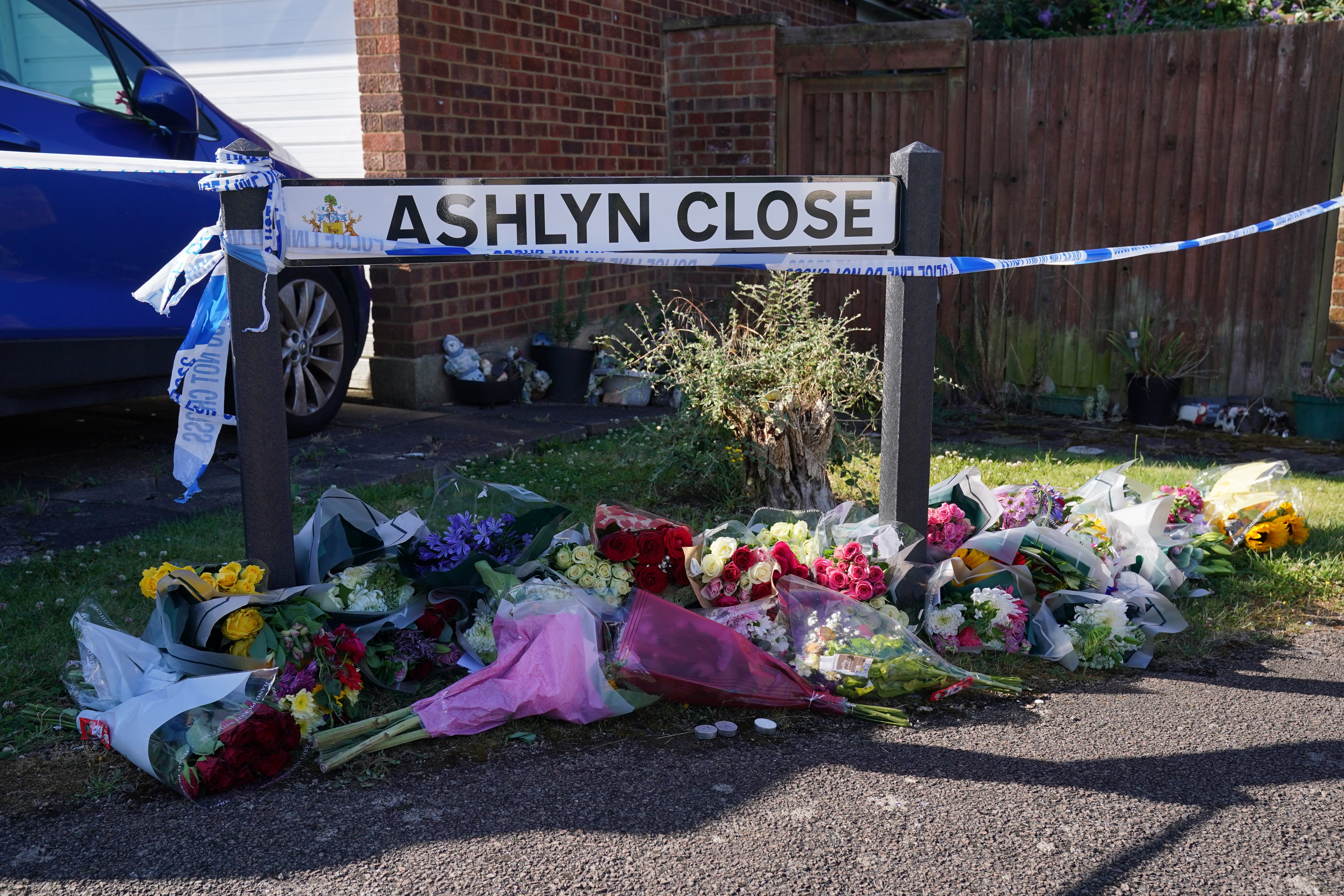 Floral tributes near to the scene in Ashlyn Close, Bushey, Hertfordshire, where Carol Hunt, the wife of BBC Five Live racing commentator John Hunt, and two of their daughters, Hannah, 28, and Louise, 25, were killed (Jonathan Brady/PA)