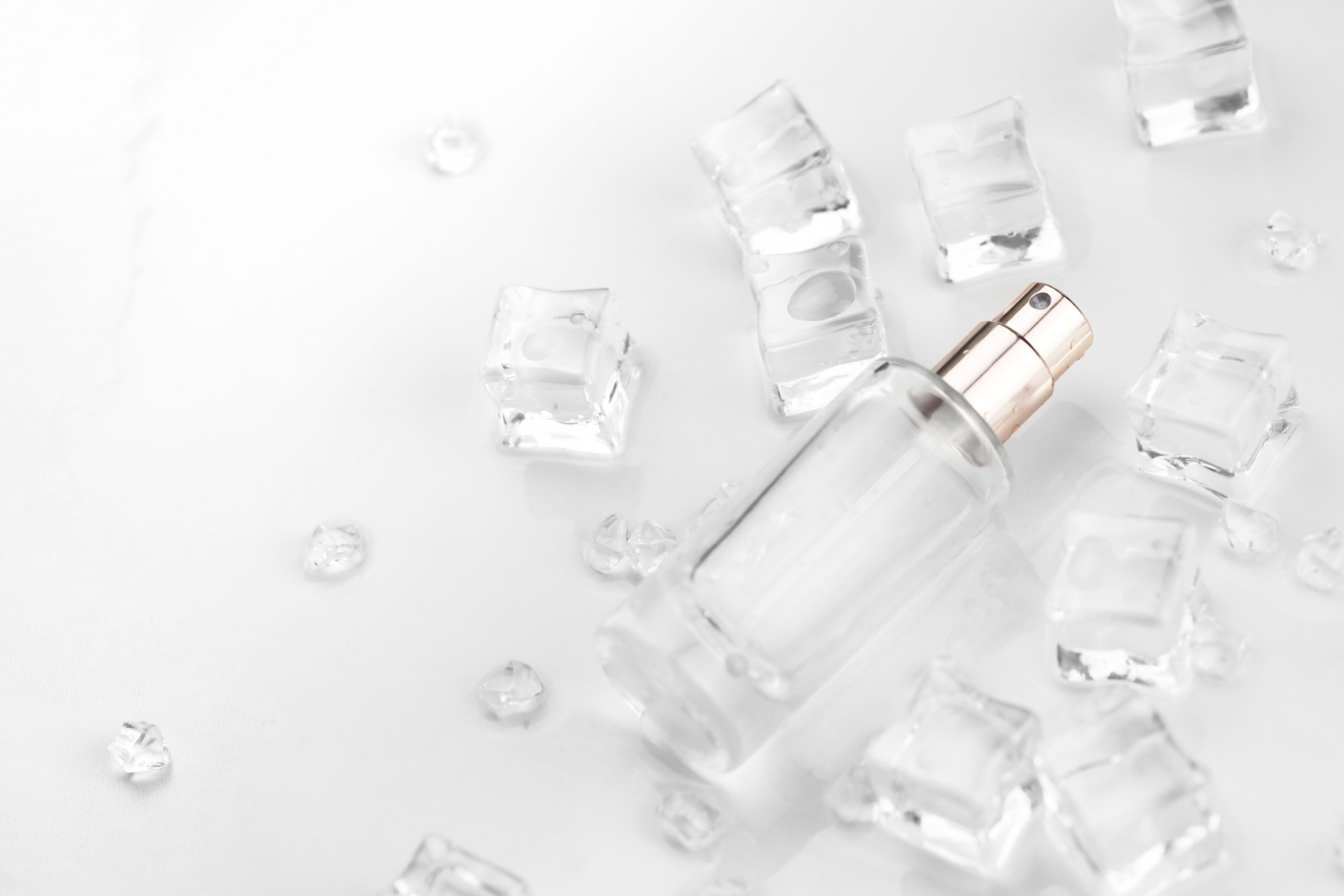 Bottle of facial toner with ice cubes