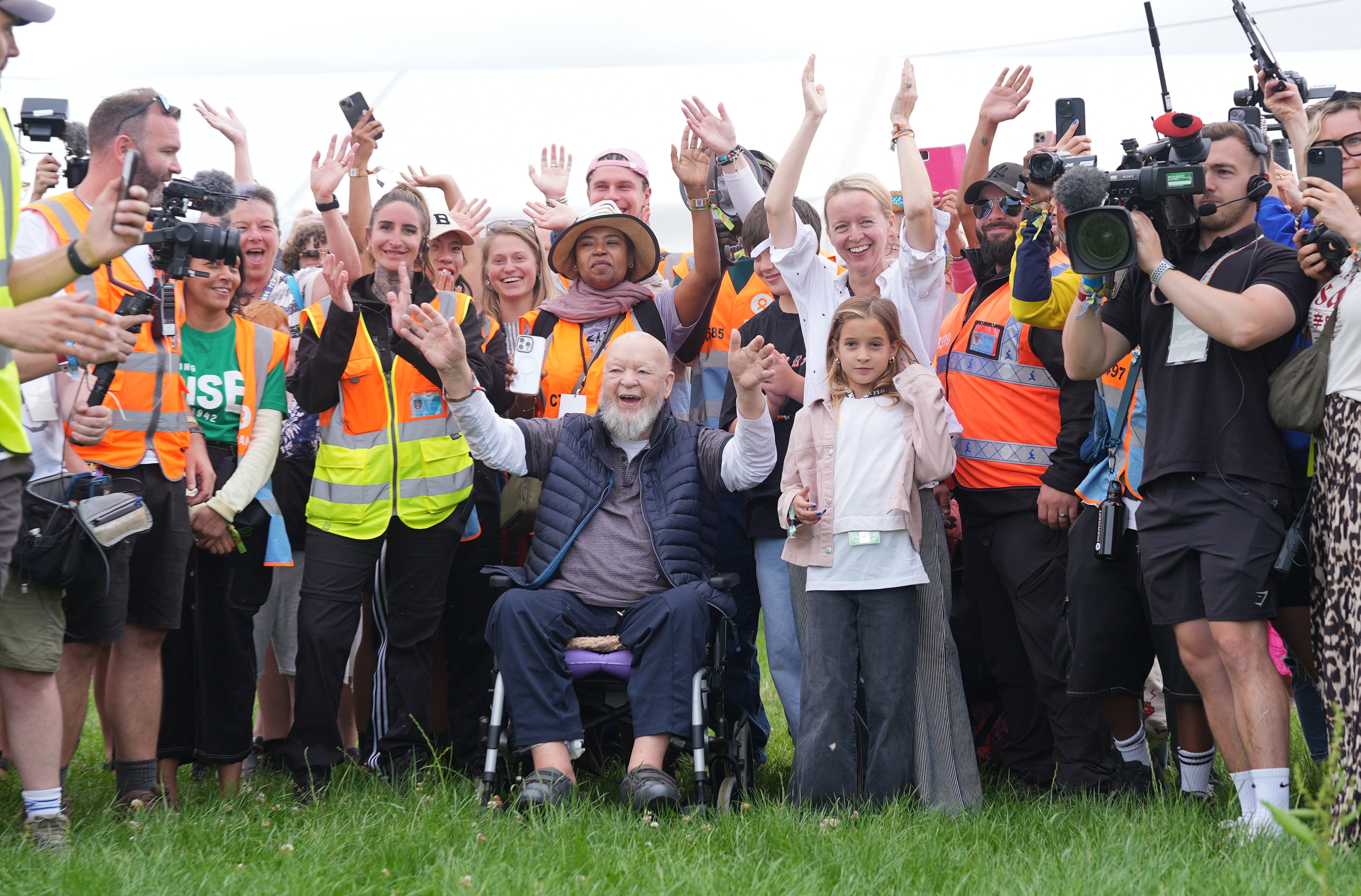 Organiser Emily Eavis and her father, co-founder Sir Michael Eavis, open the gates on the first day of the Glastonbury Festival at Worthy Farm