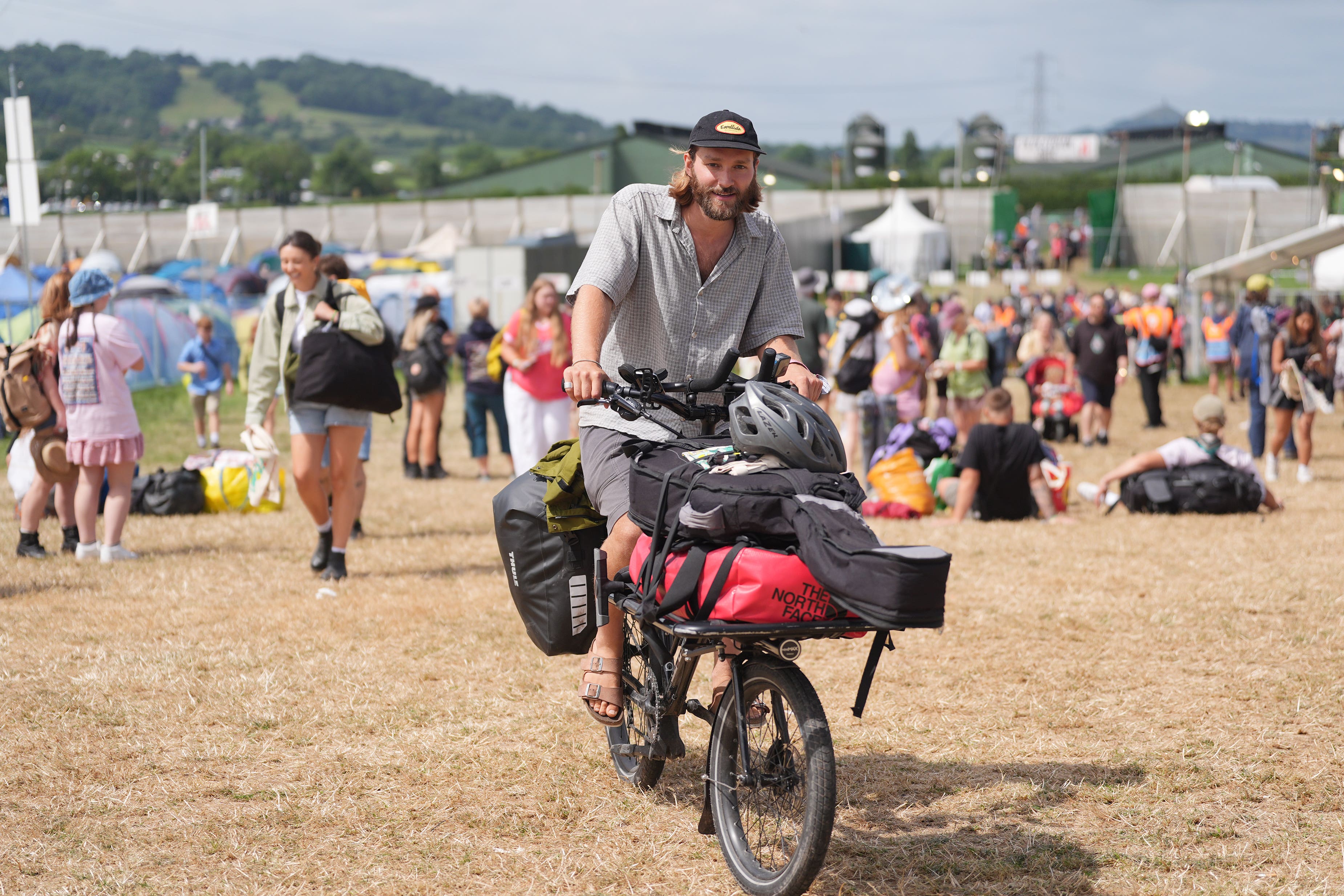British singer-songwriter Jack Cullen arrives on a bike at Glastonbury Festival at Worthy Farm after cycling more than 650 miles (Yui Mok/PA)
