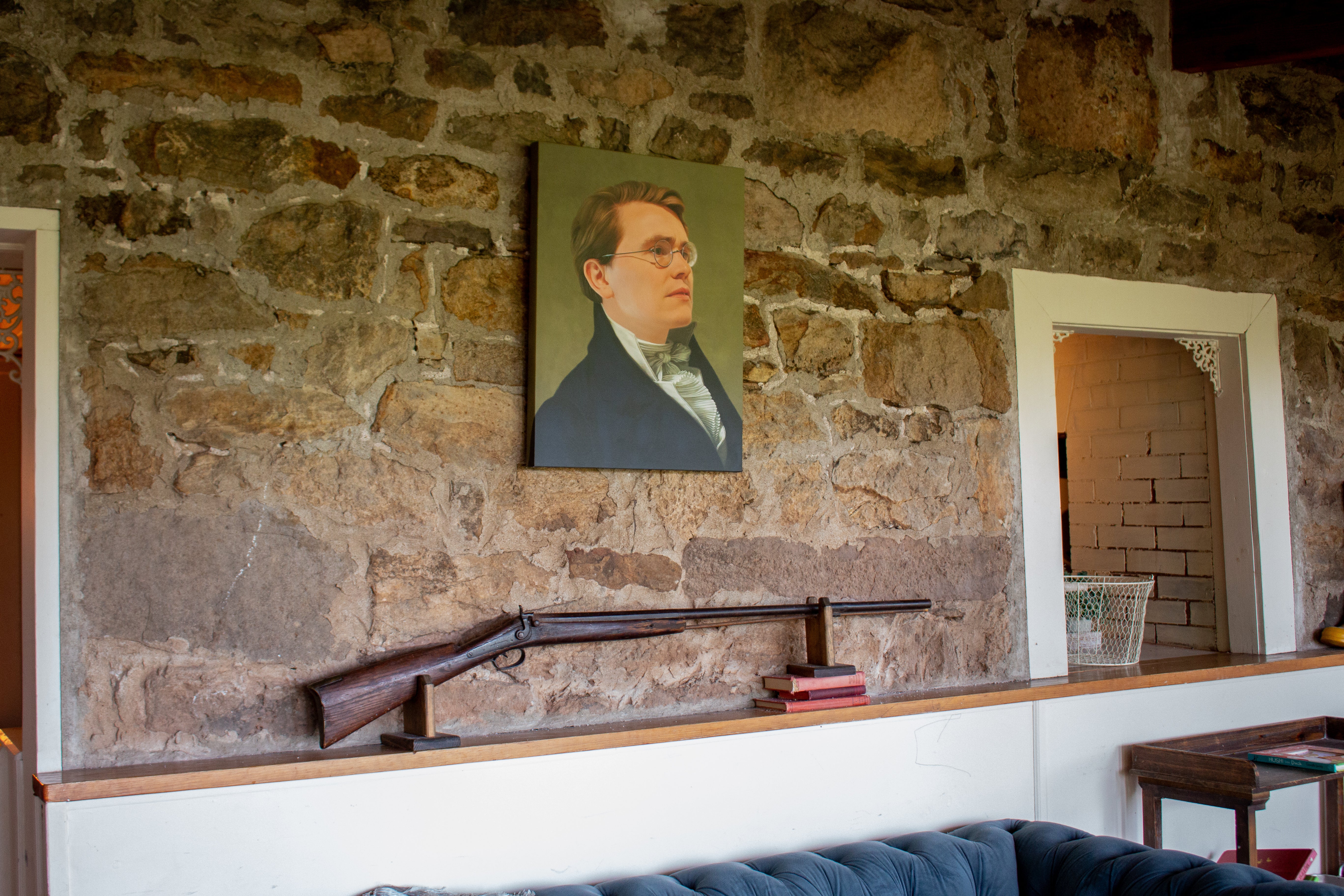 In addition to a more modern mounted AR-15, the Collinses also have a hunting rifle mounted on the wall underneath one of their many family portraits