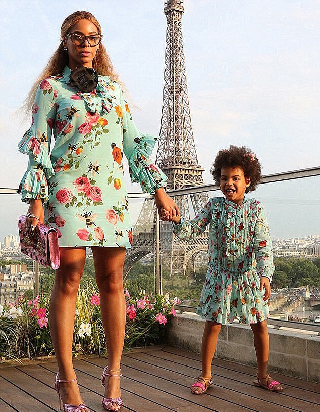 Beyonce and Blue Ivy in matching Gucci dresses with a blue rose and bee floral print by the Eiffel Tower in Paris in 2016