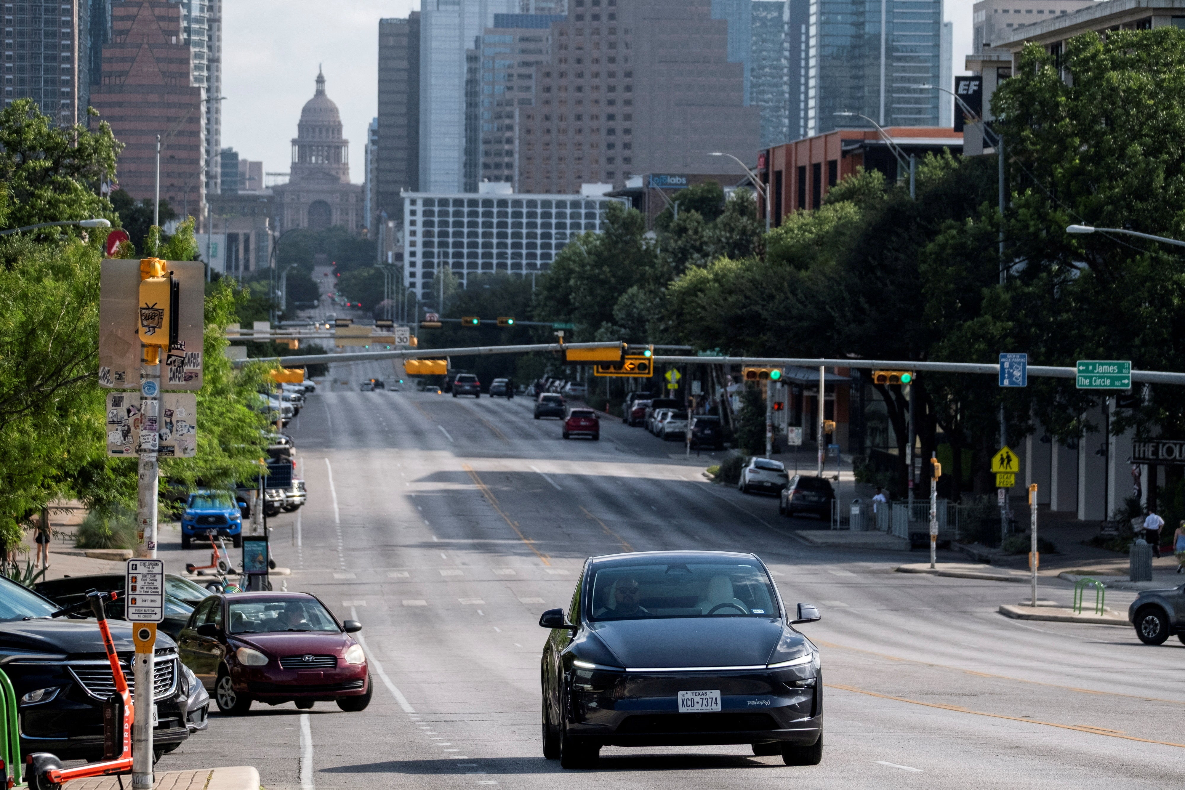 A Tesla robotaxi drives in central Austin, Texas during a test run earlier in 2025