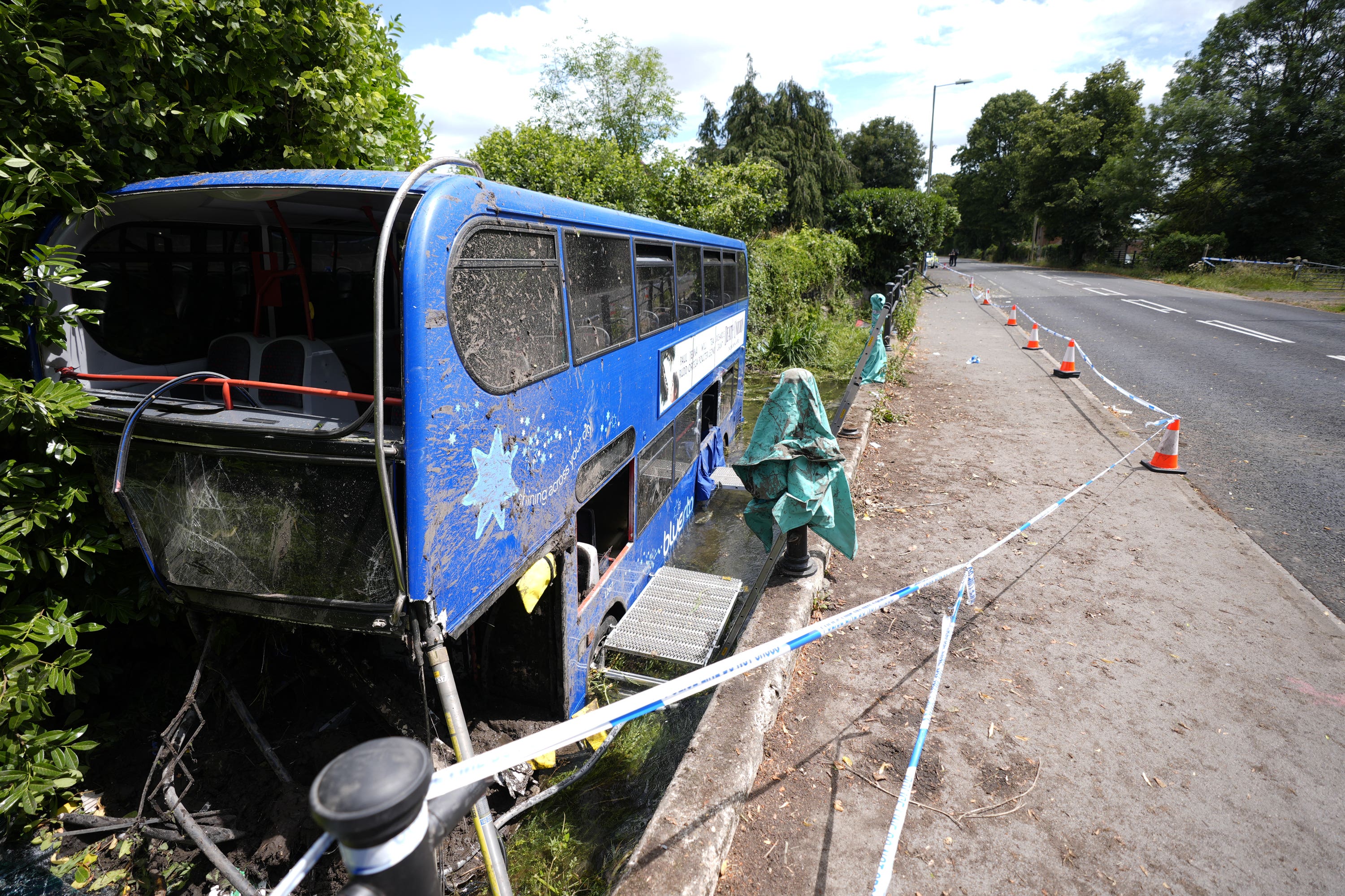 The scene at Bishopstoke Road, Eastleigh, Hampshire, after a Blustar bus carrying pupils from Barton Peveril Sixth Form College came off the road and ended up in a river (Andrew Matthews/PA)