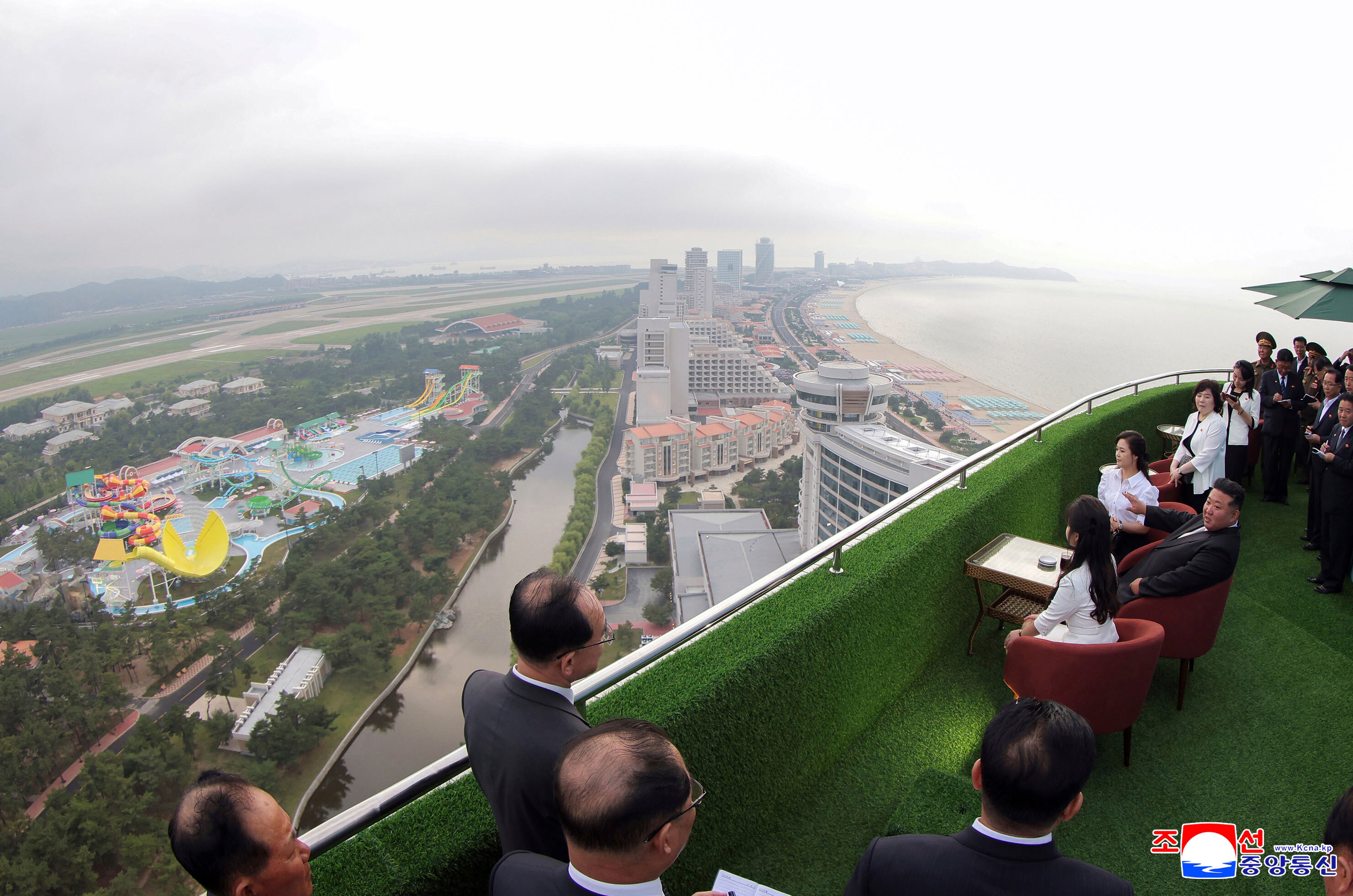 Kim, sitting center, with his wife Ri Sol Ju, rear, and daughter touring the Wonsan Kalma Coastal Tourist Zone