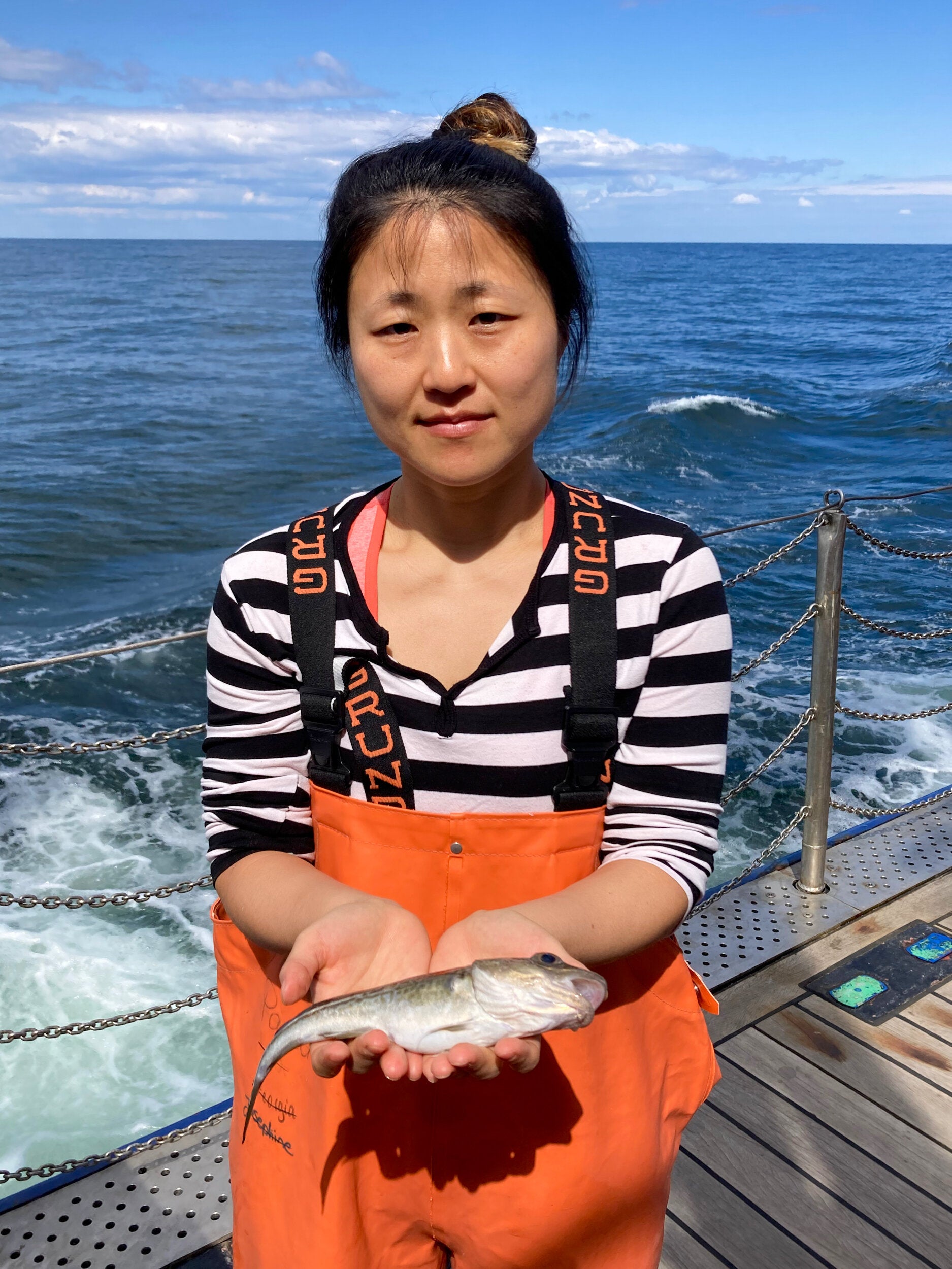 Dr Kwi Young Han holds a cod fish