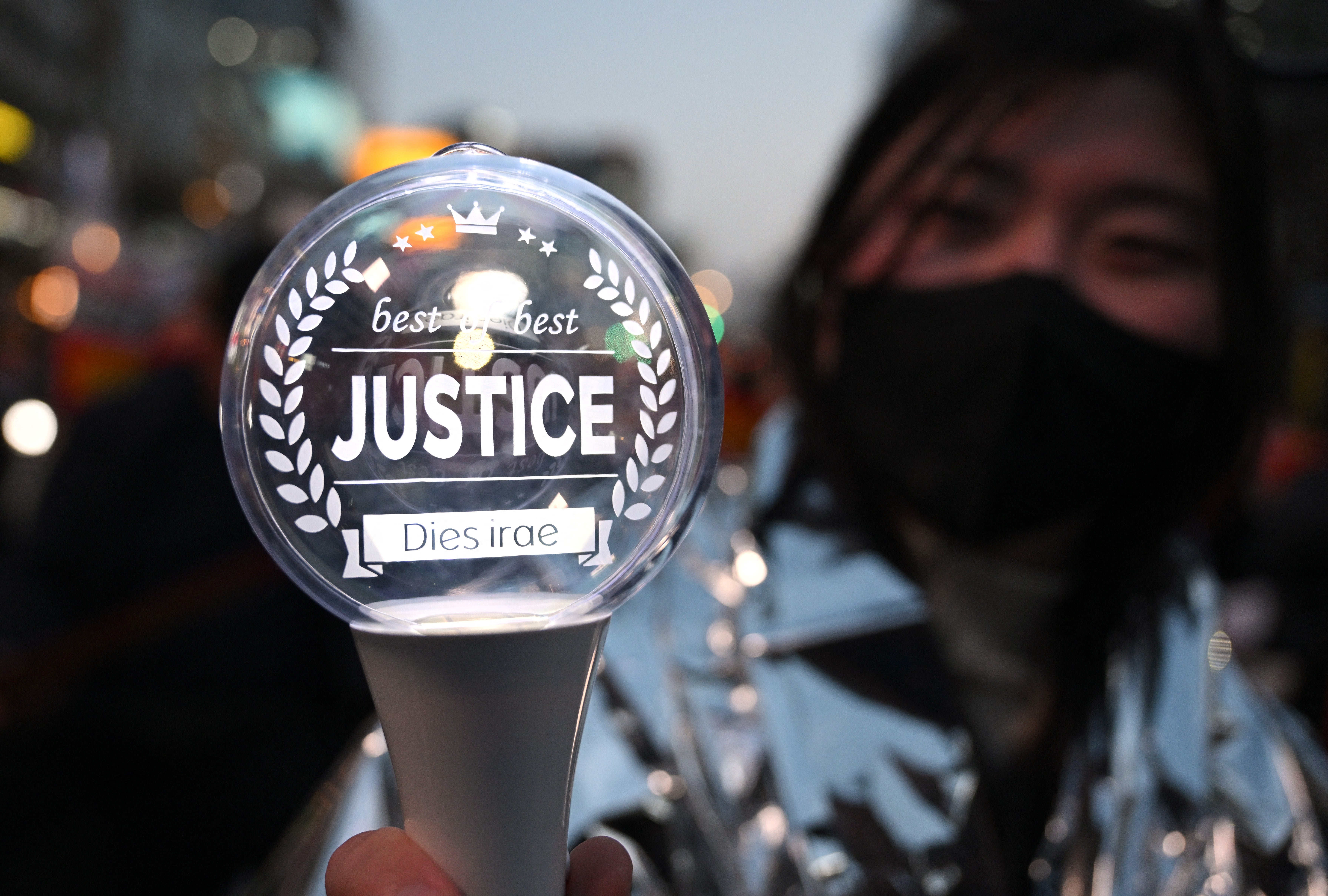 File. A protester holds a light stick reading 'justice' during a rally in Seoul on 4 April 2025