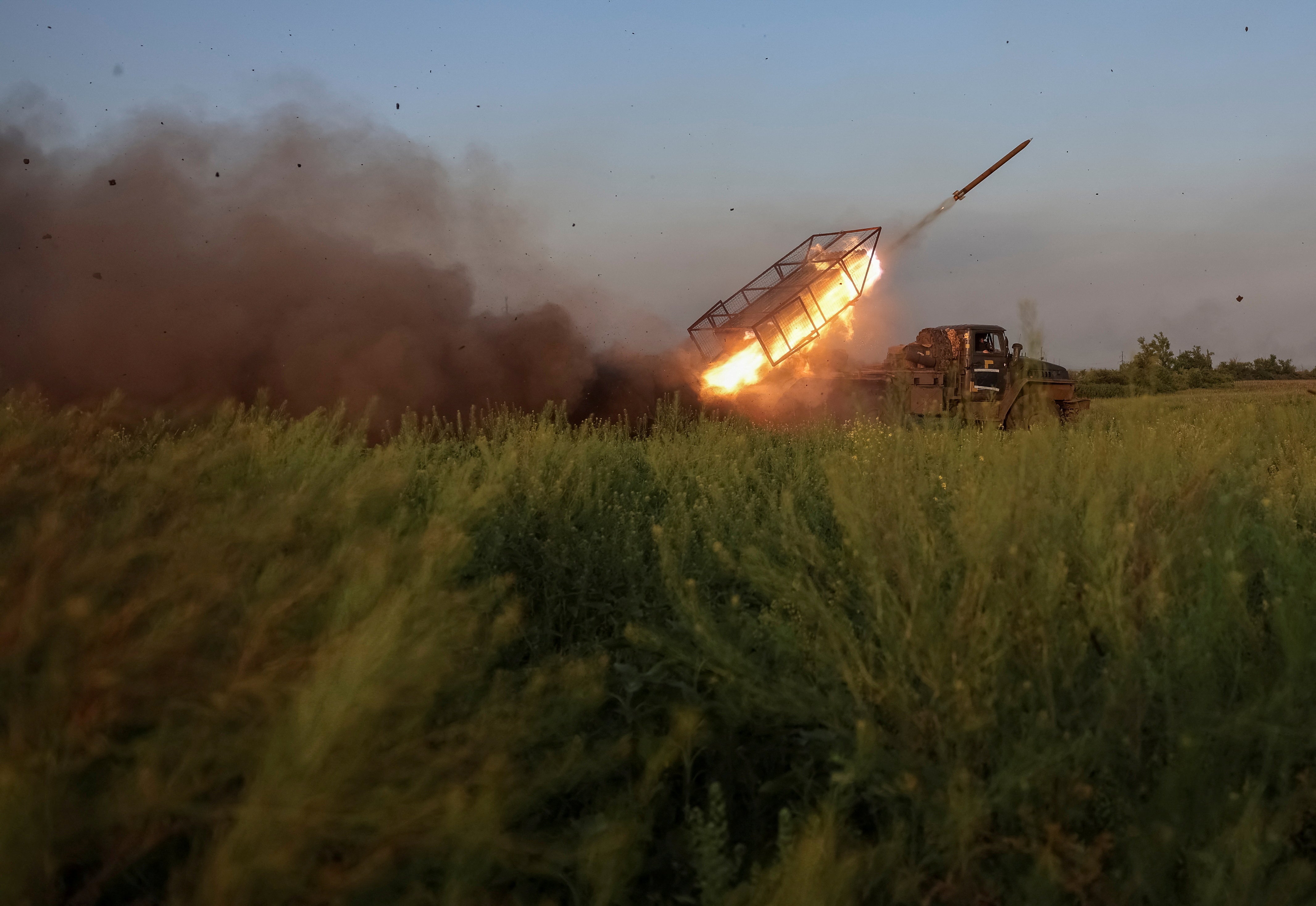 Ukrainian soldiers fire a BM-21 Grad rocket towards Russian troops