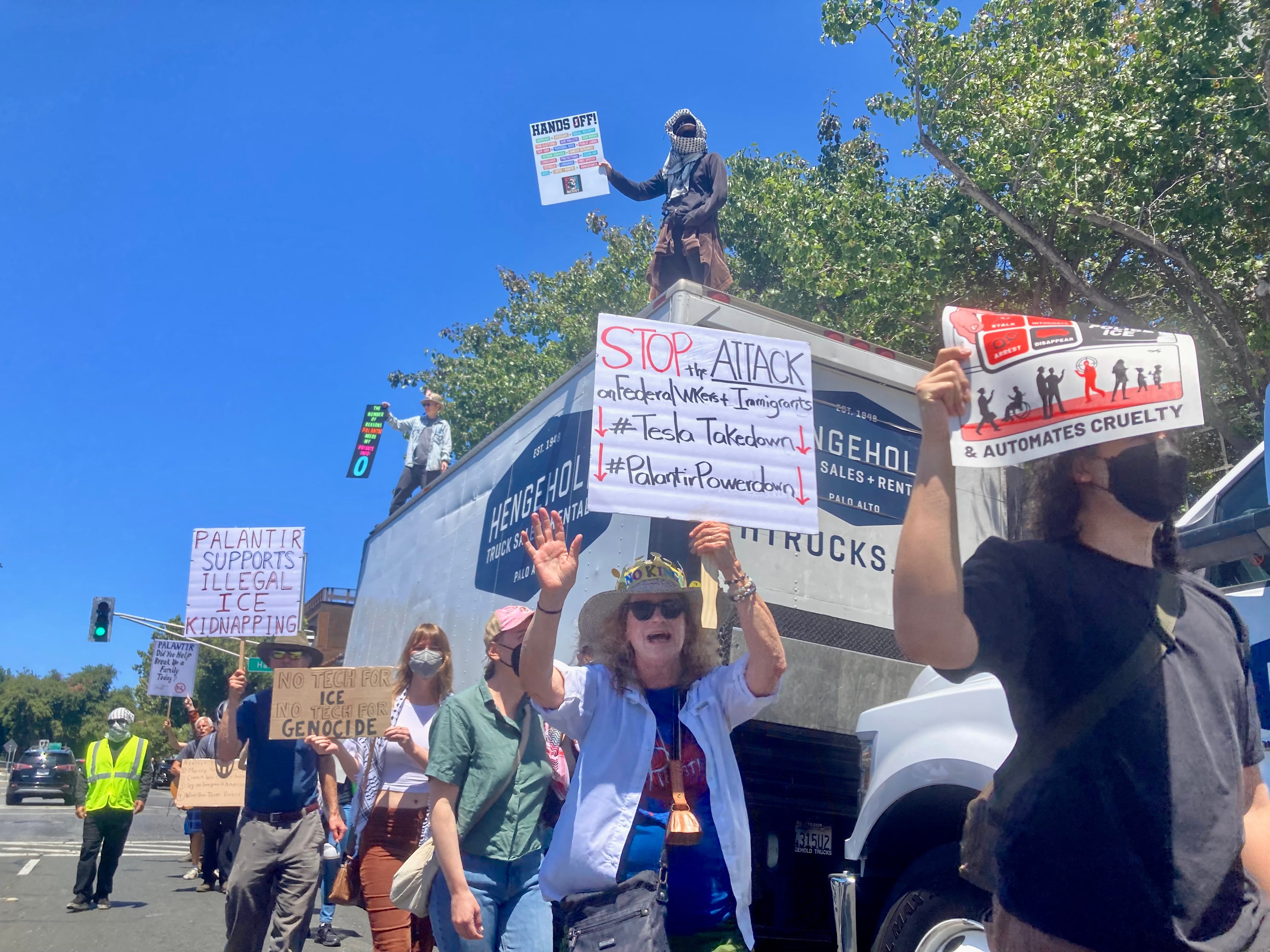 Protesters parade outside Palantir's office in Palo Alto, in the heart of Silicon Valley, on Thursday June 26, 2025