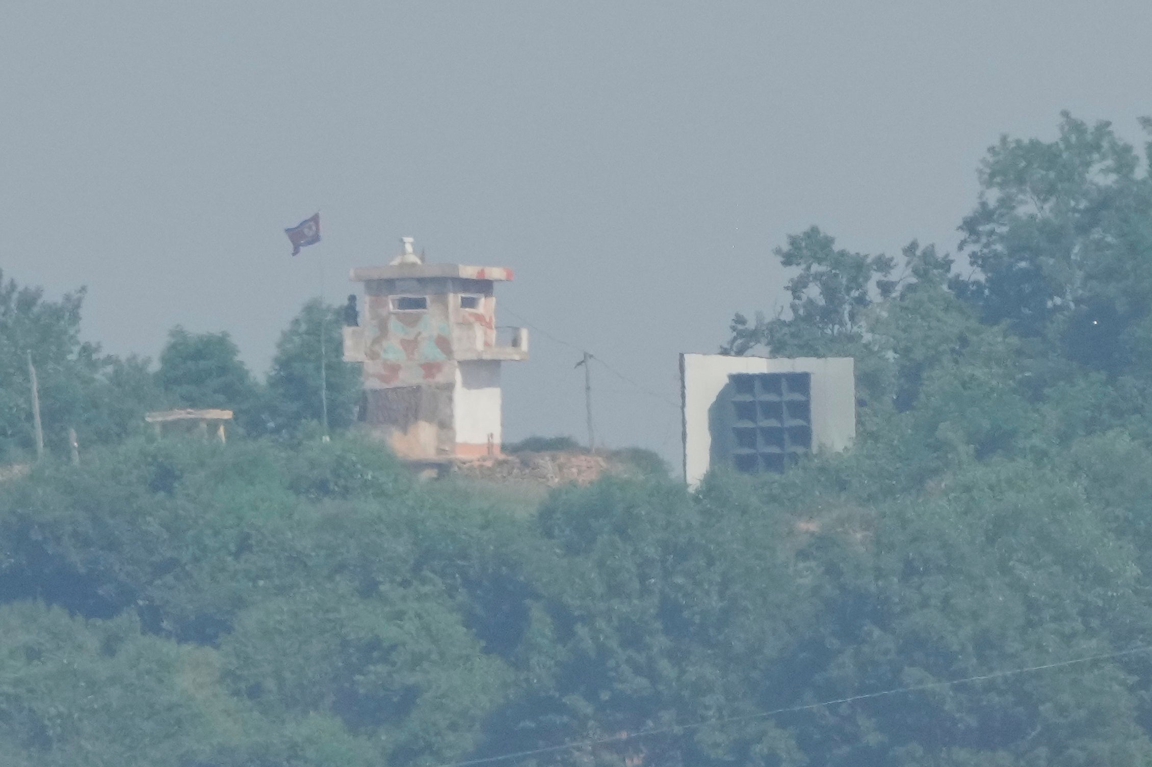A North Korean military guard post, left, and loudspeaker are seen from Paju, South Korea, near the border with North Korea, June 12, 2025. (AP Photo/Ahn Young-joon, File)