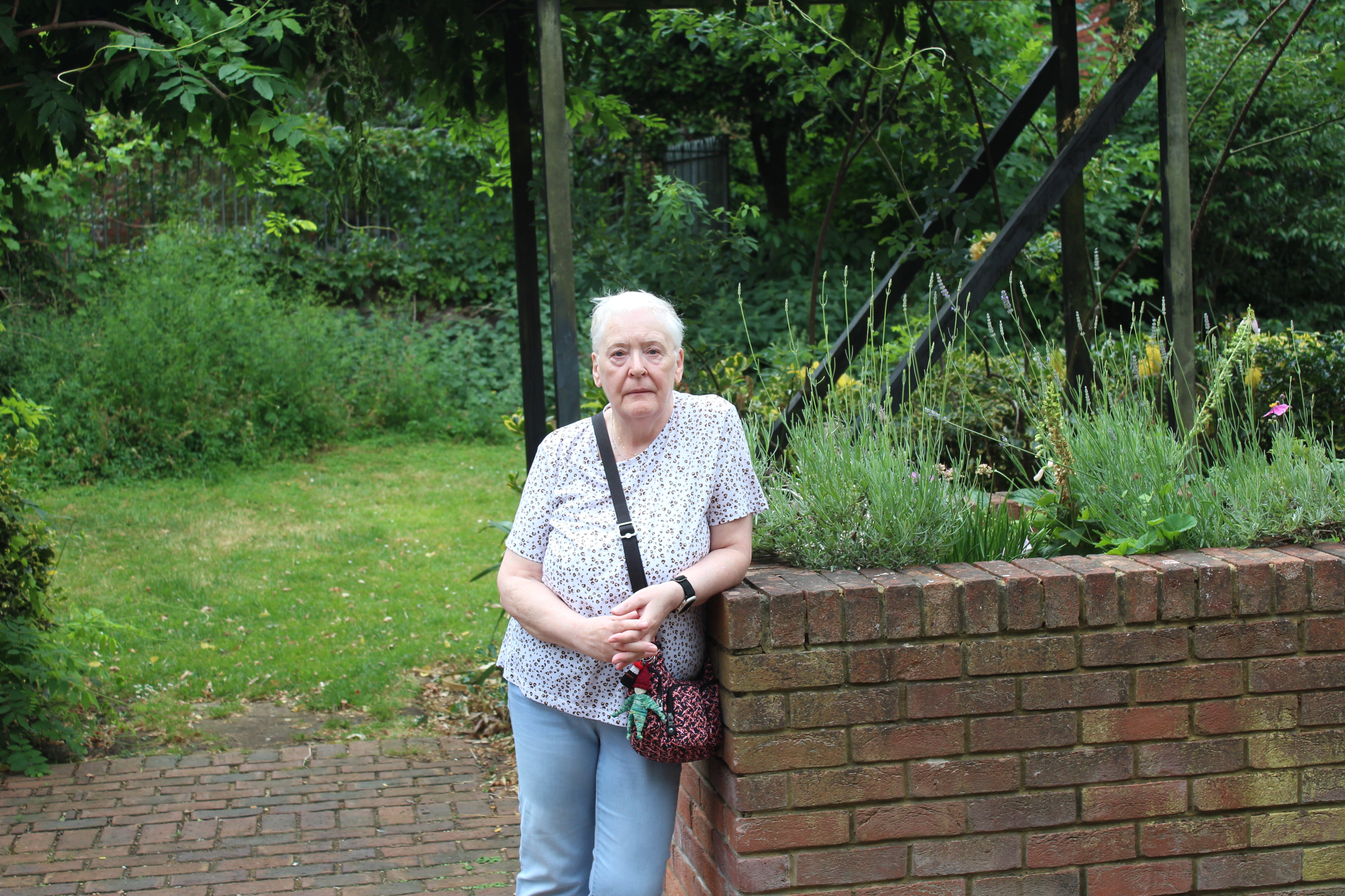Pat Findley, 73, stands in the garden room in the middle of Lillington in Pimlico