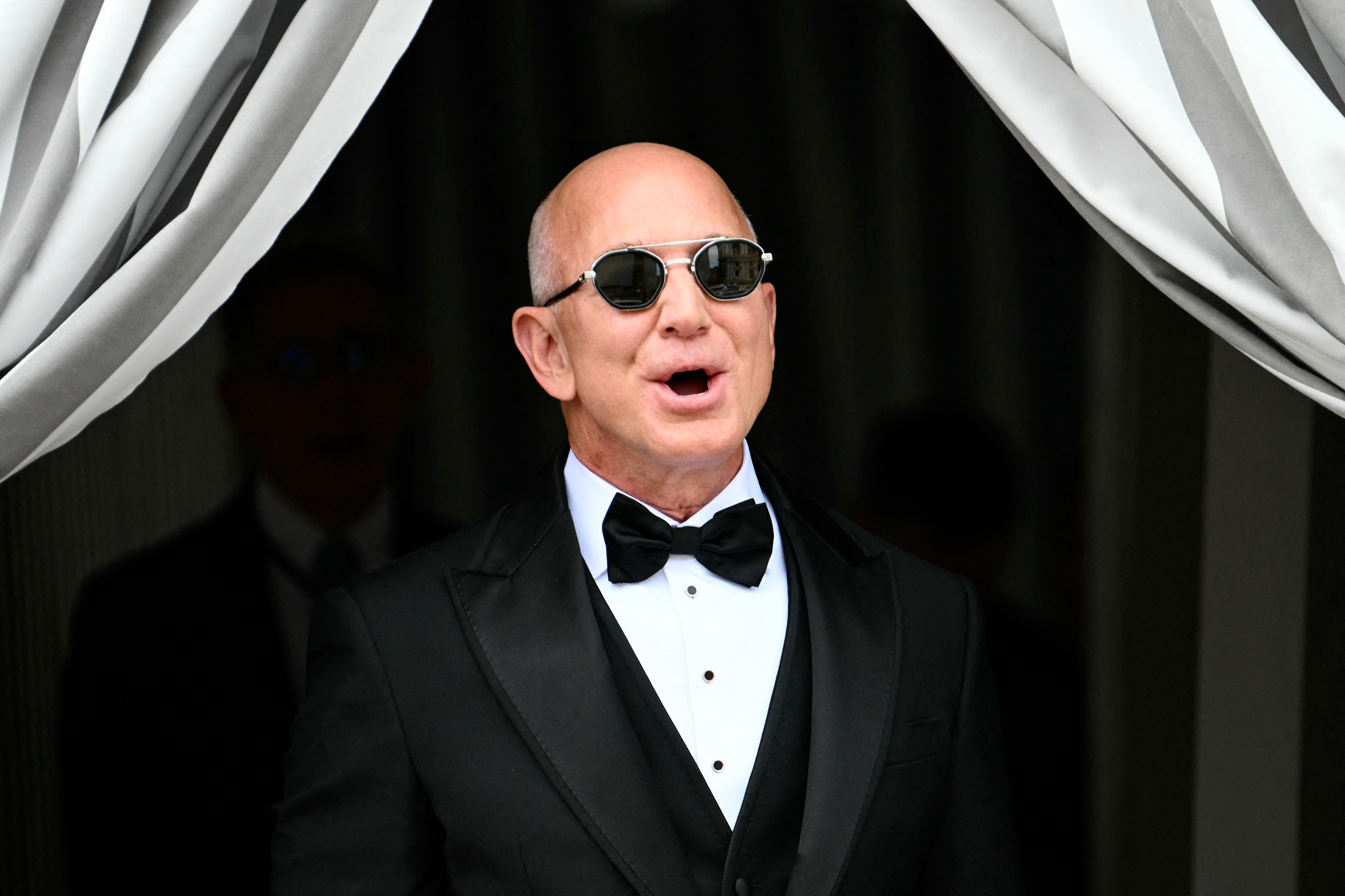 The Amazon founder teamed his black bow tie with a waistcoat and matching pair of sunglasses