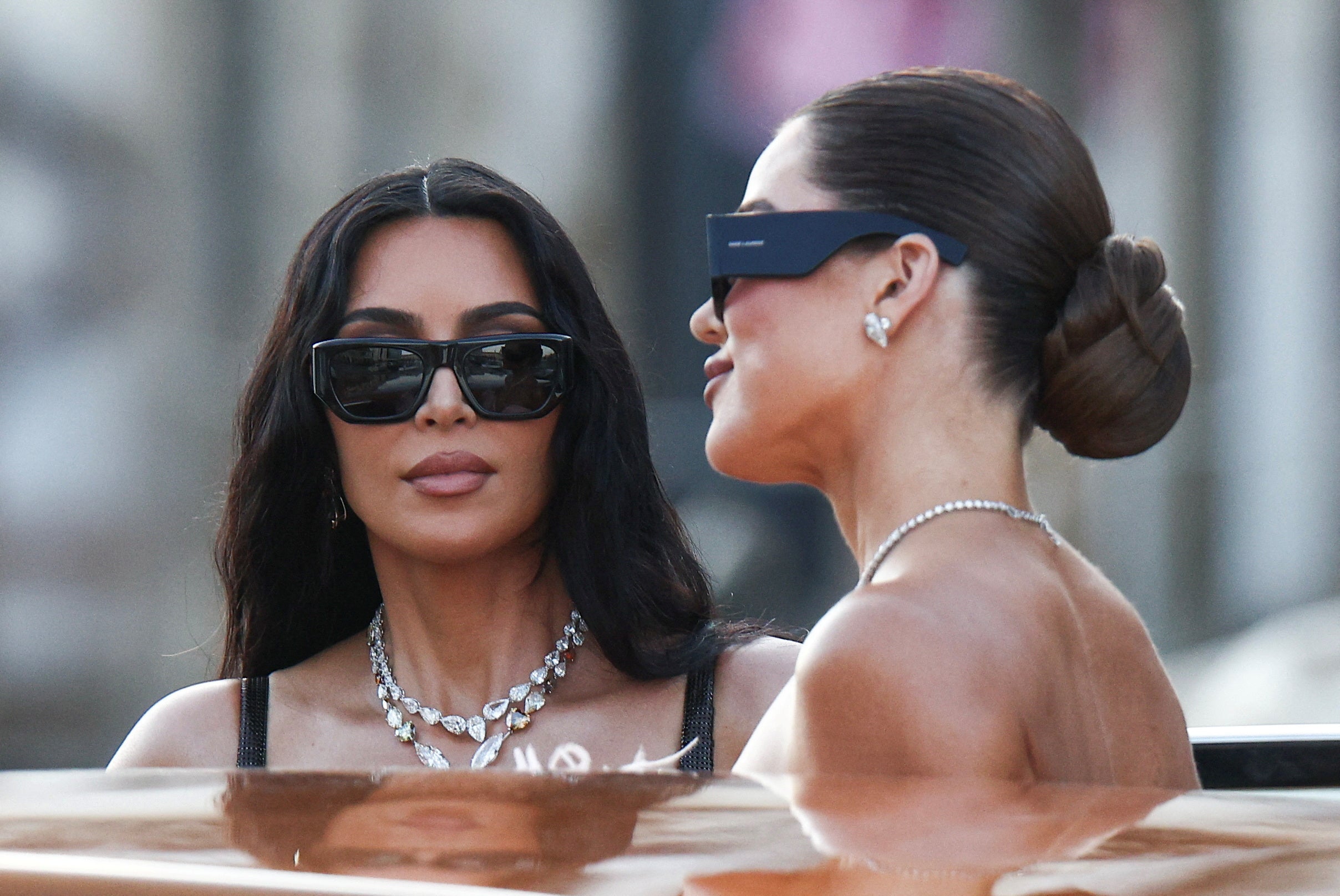 Kim Kardashian and Khloe Kardashian travel on a boat, on the second day of the wedding festivities of Amazon founder Jeff Bezos and journalist Lauren Sanchez, in Venice, Italy, June 27, 2025