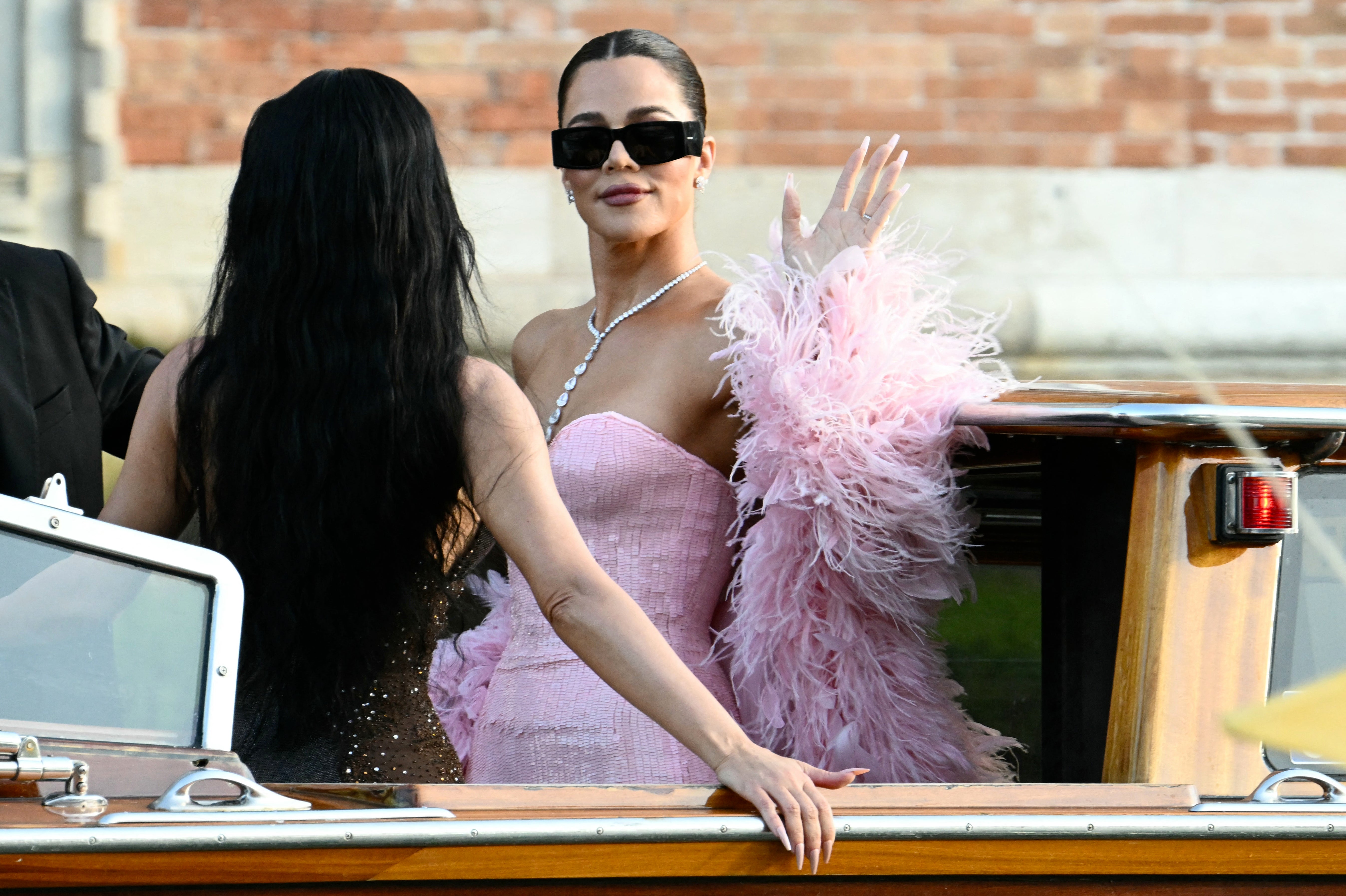 Khloe Kardashian’s wedding day attire included a tight-fitted, pale pink dress that complemented her skin tone, in addition to a matching feather boa