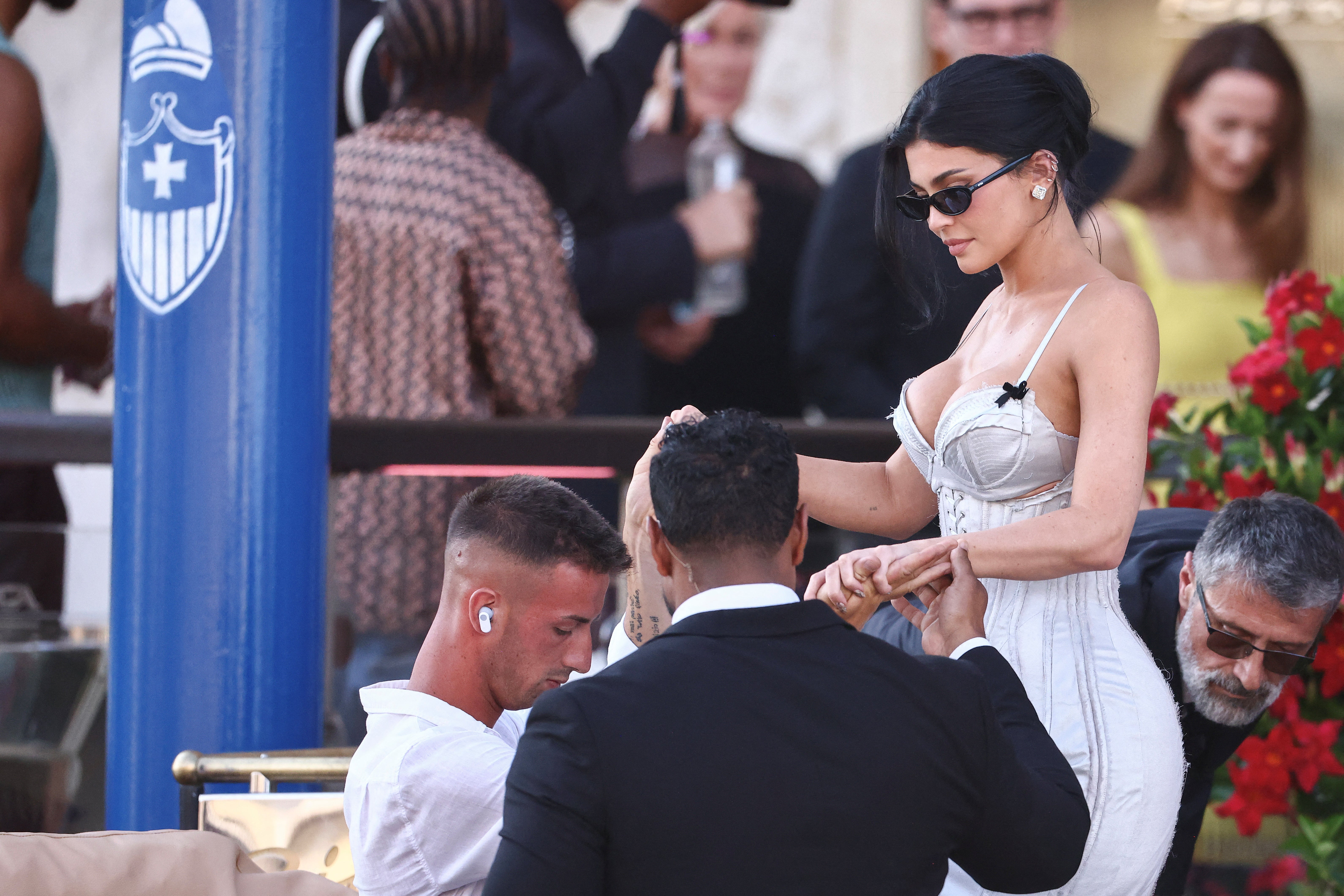 Jenner showed up on the wedding day wearing a lingerie-inspired gown. The dress was a silver or metallic blue color that many people thought was way too close to white