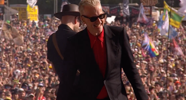 <p>Peter Capaldi on stage with Franz Ferdinand at Glastonbury</p>