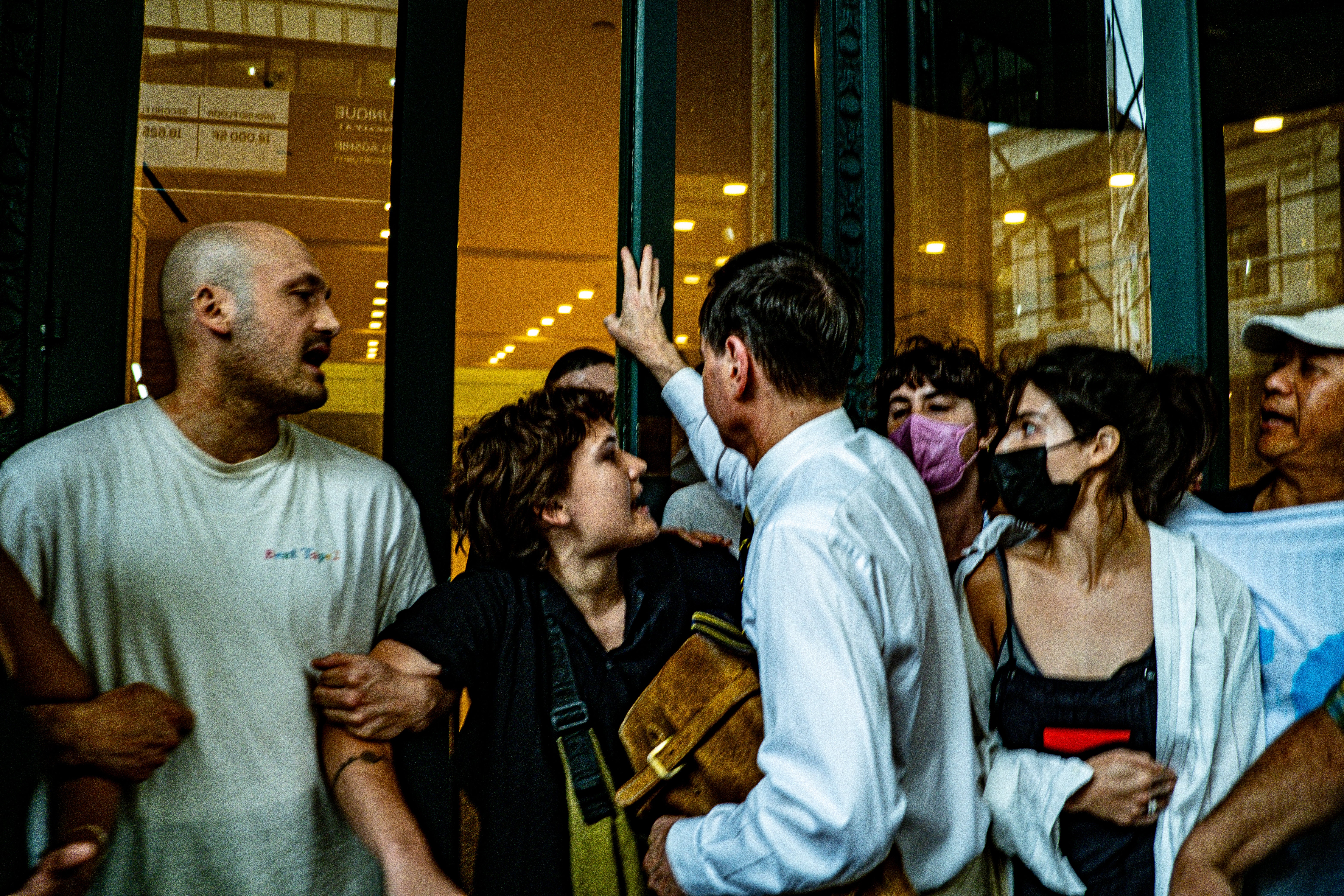 Videos and photos shared by the protest organizers in NYC show people pushing to get inside the building, as well as apparent security guards trying to muscle past protesters from inside to clear the way