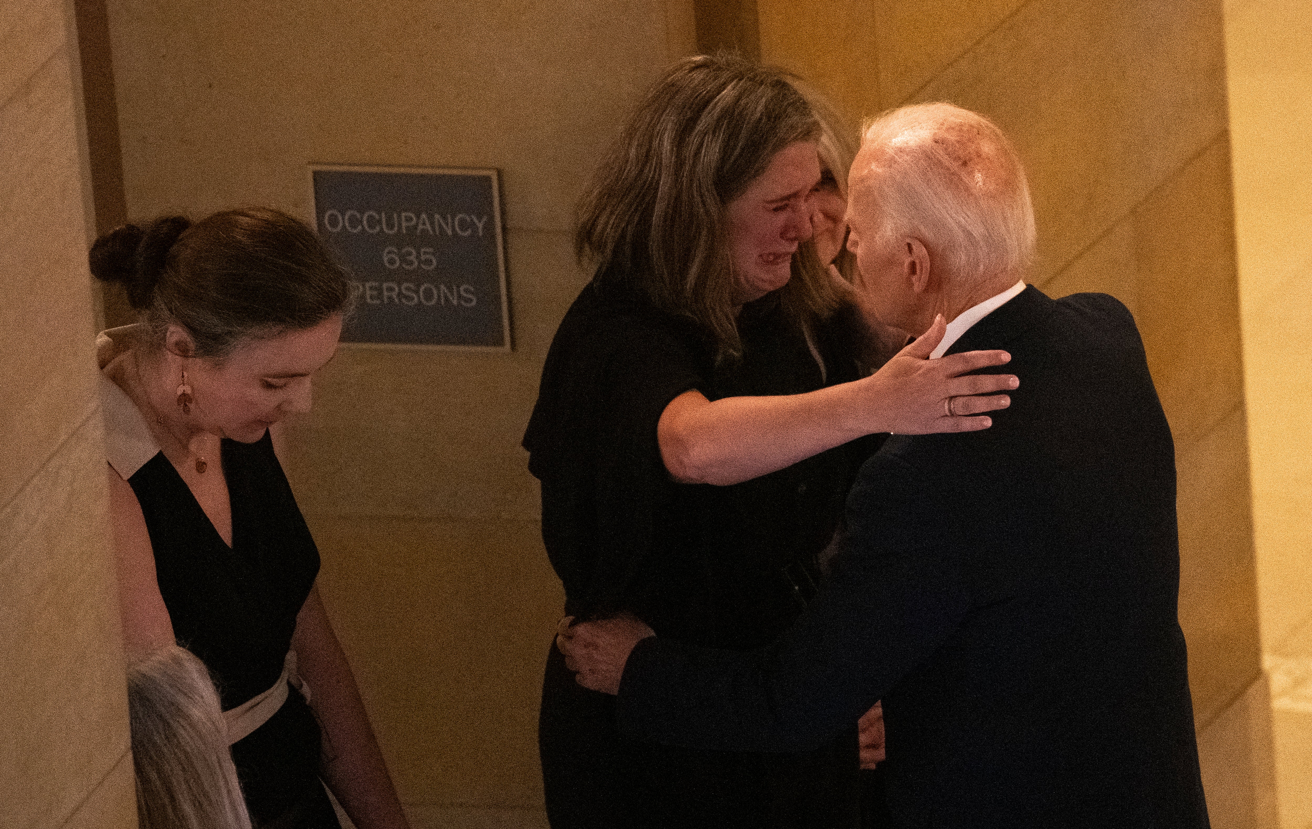 Biden embraces a mourner after viewing the caskets of Melissa Hortman, her husband Mark Hortman, and their dog Gilbert as they lay in state in the rotunda of the Capitol building in St. Paul, Minnesota on Friday