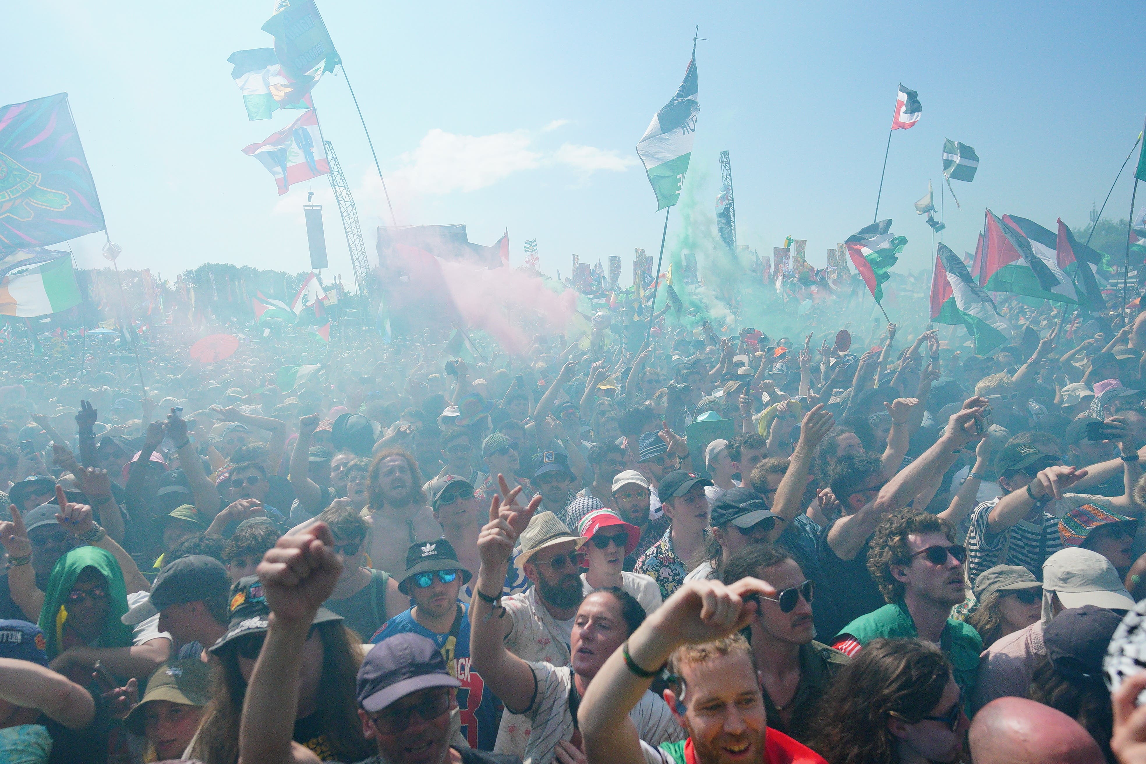 Crowds watch Kneecap performing on the West Holts Stage during the Glastonbury Festival at Worthy Farm in Somerset (Ben Birchall/PA)