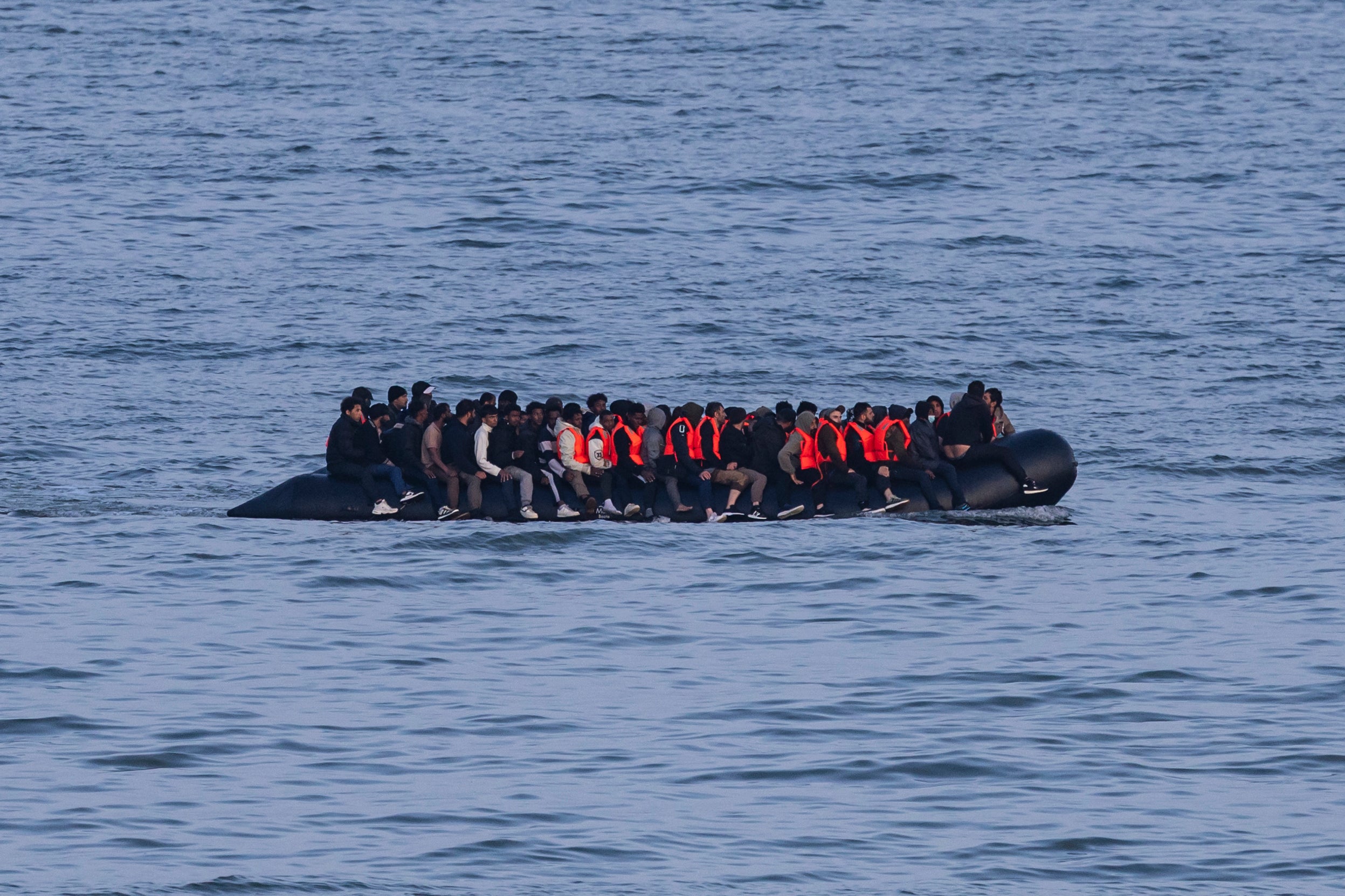 Migrants sail onboard a smuggler's boat in an attempt to cross the English Channel off the beach of Neufchatel-Hardelot, northern France on June 18, 2025